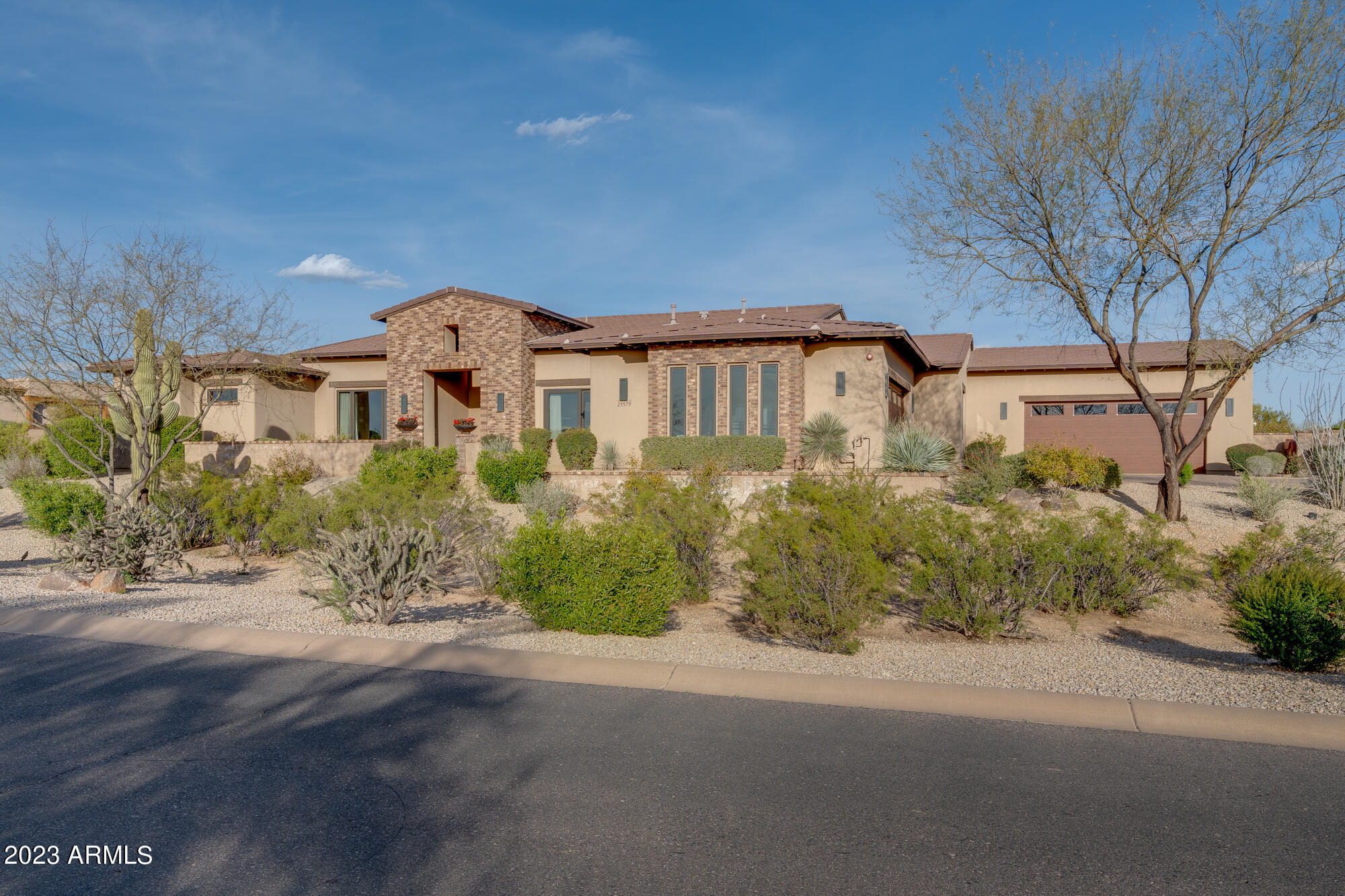 Situated on over 1.2 acres with stunning Pinnacle Peak Mtn views this custom estate will take your breath away. The moment you enter thru the 10'' custom steel door you will feel right at home. This great room floor plan  opens to the backyard via fully retractable pocket doors. The chefs kitchen includes a 48'' Wolf gas range w/dbl ovens and a large griddle. Subzero side by side SS fridge, farmhouse sink, large island, and a pass thru counter with a motorized garage door window. Walk-in pantry. Wet bar includes wine room, wine display wall, SS ice maker and mini fridge. The large master suite includes a free standing tub, his hers vanities, a large walk in closet with stacked washer/dryer. Enjoy your morning coffee with your very own coffee bar in the master suite. A beautiful solid wood barn door takes you inside the fabulous theatre/recreation room with full size fridge, wet bar, sonic ice maker, and candy dispenser wall. This room can be converted to an additional 5th bedroom with access to the Jack n Jill bath. Your guests and family will love the attached yet very private guest casita. This casita has it's own connecting 2 car garage. Enter the casita by side door, garage, or from within the main house. Features include 800 sq feet of livable space with with bedroom, bathroom, full kitchen, and motorized garage door wall which opens to  back patio/backyard to enjoy the Arizona weather all year round. The backyard paradise includes a heated pool/spa with a swim up bar. Covered gazebo. Firepit. Built in BBQ, putting green, and turfed area with cornhole play. No expense was spared in this stunning custom home. It is truly a place to entertain and enjoy all year round. 

Interior Features:
- wide plank French oak wood through out
- 5" baseboards throughout
- large laundry room with built in storage wall, and sink
- control 4 smart home automation
- surround sound
- alarm
- built in garage cabinets
- theatre room/recreation room has access to jack n jill bathroom to make it an additional bedroom if needed
-office/den

Exterior Features:
- backyard paradise with heated pool and spa
- swim up bar
- turfed area with cornhole
- putting green
- firepit
- covered gazebo
- built in BBQ with "Green Egg" smoker
- low maintenance yard

Appliance Features:
- Sub Zero refrigerator/freezer built-in SS
- Wolf gas range 48" SS w/extra large griddle
- custom hood 48"
- ice maker at wet bar SS
- mini fridge at wet bar SS
- mini fridge in master bedroom

Cabinetry Features:
- soft close drawers and doors at all locations

Energy Efficiency Features:
- R-19 exterior walls, R-38 at roof, R-11 at bedrooms, bathrooms and laundry
- dual pane windows
- insulated Cloplay garage doors
- variable speed pool pump

Plumbing Features:
- toilets with soft close seats
- RO system at kitchen sink
- 2 Hot water heaters

Electrical Features:
- 6" recessed cans throughout home

Heating and Cooling Features:
- 3 heating and cooling units

Garage Features:
-(2) 2-Car garages, one connected to main house and one connected to guest casita entrance. Both have built in cabinets and lots of storage.