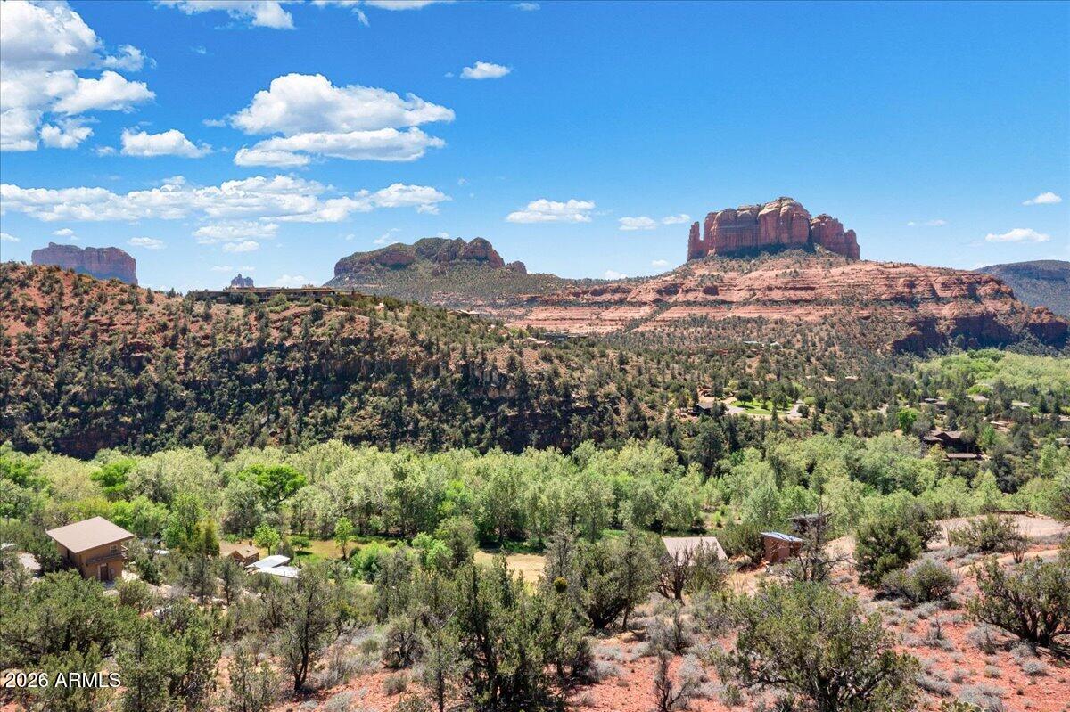 Perched within Mystic Heights, one of Sedona's most coveted private enclaves, this nearly one-acre parcel offers a rare synthesis of seclusion, accessibility, and some of the most compelling views in Red Rock Country. Positioned across Oak Creek from the iconic face of Cathedral Rock, the site commands a perspective that few buildable lots in Sedona can rival.
The land is ready for a custom residence of genuine architectural ambition. Mystic Heights imposes the kind of low-density, high-caliber environment that protects long-term value and ensures the neighbors you never see are the ones who matter most. Trail access and the creek itself lie in close proximity, putting Sedona's natural landscape within reach without sacrificing the privacy of an elevated residential setting.