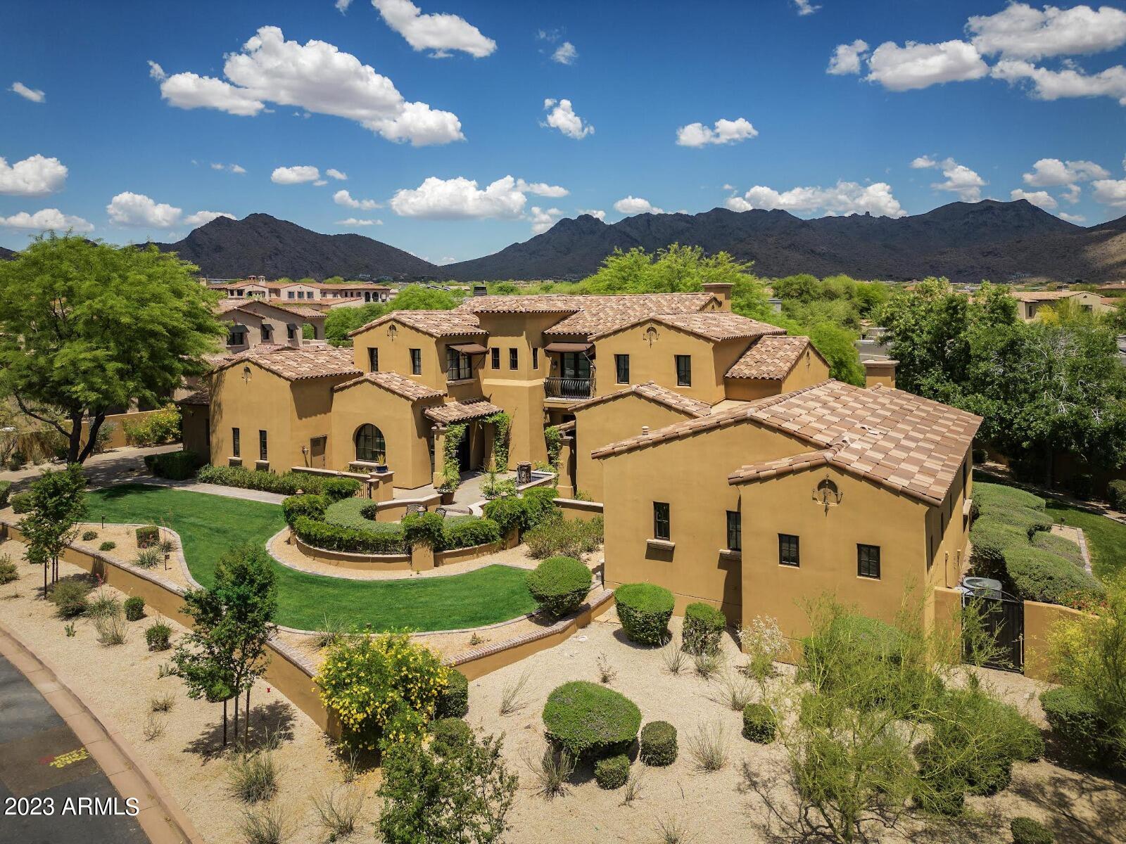 Experience the charm of luxury living with this stunning Spanish-inspired home nestled among 130 homesites in the exclusive Silverleaf Arcadia enclave of DC Ranch. As you approach, you'll be greeted by a picturesque courtyard with a tranquil fountain, setting the tone for the elegance and sophistication that awaits. Step through the grand front door and be awed by the soaring ceilings of the great room, complete with oversized sliding doors that seamlessly connect the indoor and outdoor living spaces. The fully remodeled kitchen is a chef's dream, boasting top-of-the-line appliances and ample counter space to entertain with ease. The main level of the home features the gracious master, an entertainment room, a guest suite with private access, and an office provide added convenience.