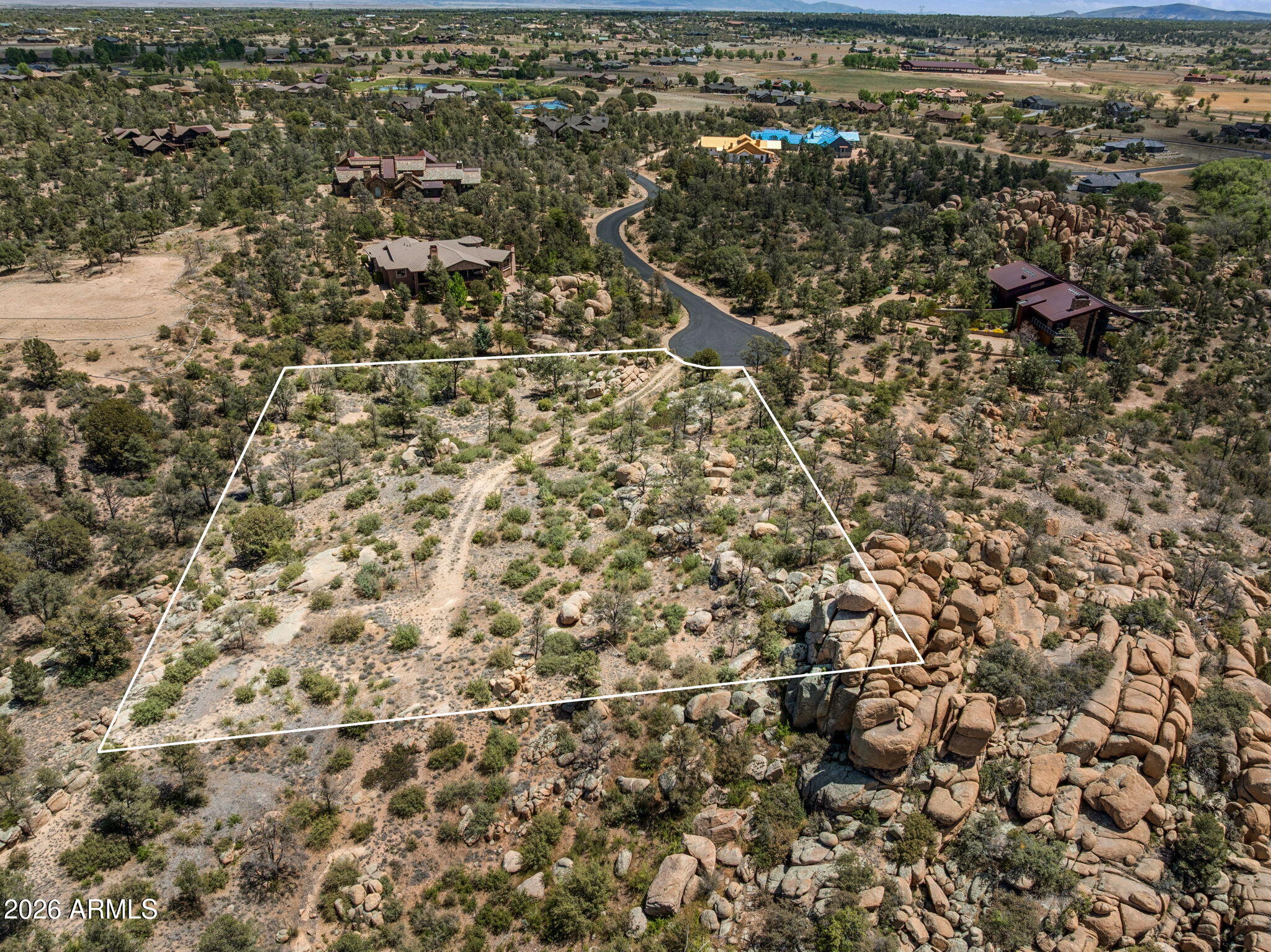Located in the prestigious American Ranch community of Prescott's sought-after Williamson Valley area, this exceptional 2.65-acre is surrounded by some of Northern Arizona's most stunning natural scenery.  The property backs directly to the Prescott National Forest, providing unmatched privacy, open space, and immediate access to miles of hiking, riding, and outdoor recreation.  With its cul-de-sac setting, the lot enjoys a peaceful, quiet atmosphere ideal for those seeking serenity and seclusion. 
Natural features include dramatic boulder outcroppings, mature pine trees, and gently varied terrain, creating a picturesque landscape. Expansive panoramic views of mountains, forest, and valley vistas enhance the beauty and appeal of this property.