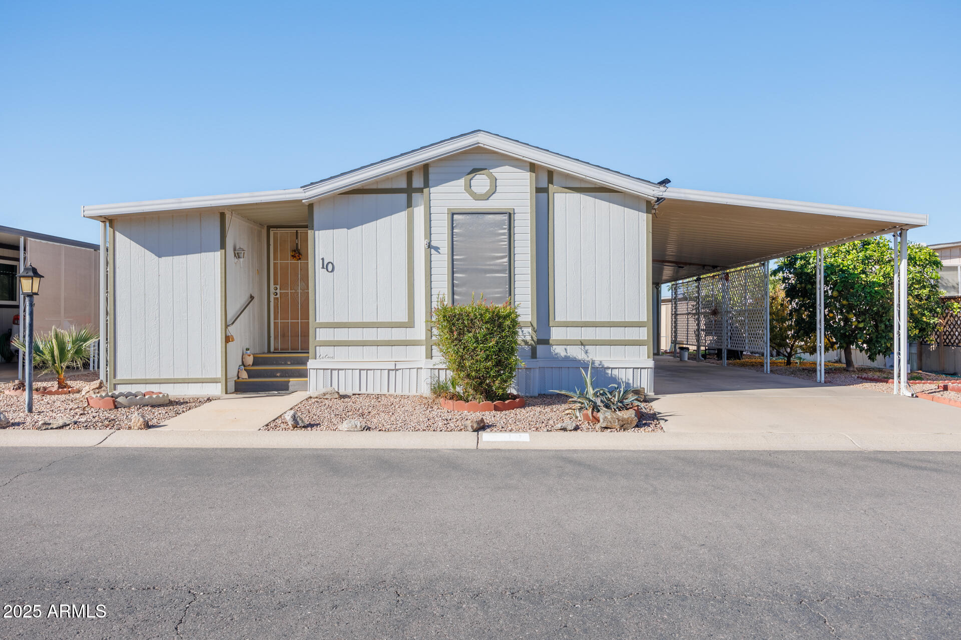 A charming 2-bedroom, 2-bath home featuring a bright Arizona sunroom filled with natural light. Recent upgrades include new vinyl flooring and an energy-efficient AC unit for modern comfort. The primary bathroom offers an accessible walk-in tub along with updated plumbing, including new water lines and shut-off valves. An open kitchen and living area create a spacious, welcoming feel. Additional highlights include a storage shed, covered parking, and a wheelchair ramp for added convenience and accessibility—ideal for comfortable, easy living.