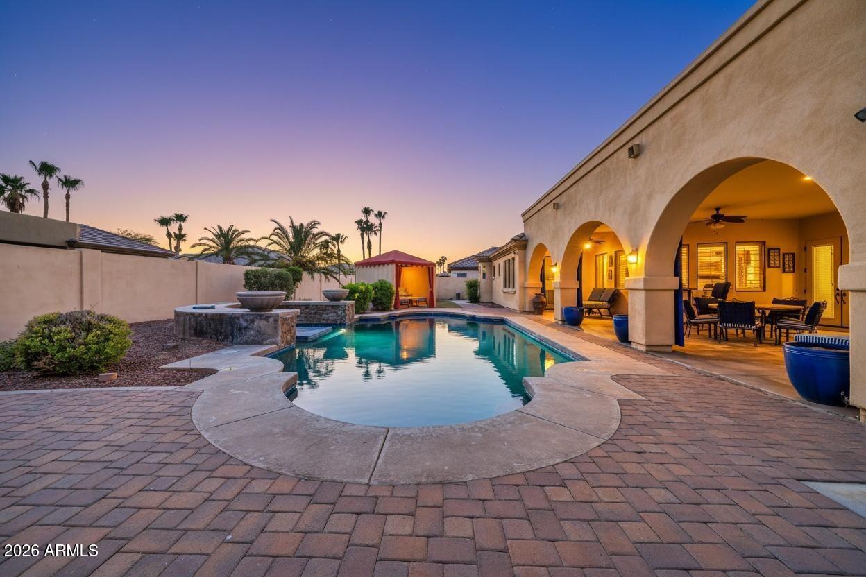 Welcome to Russell Ranch, an exclusive gated community known for its oversized homesites, luxury residences, and elevated lifestyle. Situated on an expansive 18,000+ square foot lot, this extraordinary estate was thoughtfully designed with both sophistication and everyday living in mind.
Offering 5 bedrooms and 3.5 bathrooms, every bedroom is uniquely appointed with its own sitting area, creating private retreats throughout the home. The primary suite is truly one-of-a-kind, a luxurious sanctuary featuring direct access to the resort-style backyard, a private courtyard with dual-sided fireplace, and an attached flex retreat perfect for a home gym, office, wellness room, or secluded lounge space. Designed for seamless living and entertaining, the home features plantation shutters throughout, a spacious teen/flex room, formal dining room, expansive family room, and an inviting eat-in kitchen. The family room showcases a custom built-in entertainment wall with ambient lighting, gas fireplace, surround sound, and a hidden AV equipment closet for a clean, modern aesthetic.
At the heart of the home lies the beautifully renovated chef's kitchen, complete with an oversized island, granite countertops, gas cooktop with built-in griddle, Viking refrigerator, dual built-in JennAir ovens, travertine backsplash, beverage station with wine fridge, and an oversized walk-in pantry accented by a stunning custom wrought iron door.
Step outside to your private entertainer's paradise. The backyard was designed for unforgettable gatherings and everyday enjoyment alike, featuring extensive paver hardscaping, a basketball court, raised outdoor kitchen with refrigerator and charcoal grill, sparkling pool, outdoor shower, and a custom cabana designed for ultimate relaxation.
This is more than a home; it's a lifestyle destination where luxury, comfort, and thoughtful design come together beautifully.
