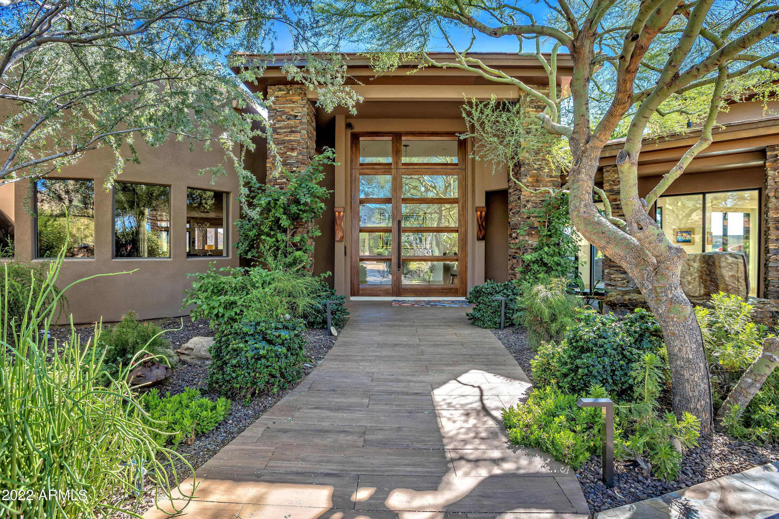 Welcome to Desert Highlands #1! The Epitome of Multigenerational Resort-Style Living. This extraordinary estate, nestled on a sprawling 2.6 acre private cul-de-sac homesite, offers IMMEDIATE full Club membership, providing you with access to a wealth of exclusive amenities.

Step onto the pavered, circular drive, and you'll be greeted by a private garden courtyard with lush landscapes, setting the tone for the remarkable lifestyle that awaits. This home underwent a remarkable $6 million total re-imagination in 2019, resulting in a smart, transitional luxury masterpiece. Every detail meticulously curated, and no expense spared to create this stunning residence.

Inside the main home, you'll find an array of sophisticated spaces, perfect for hosting large gatherings, as well as comfortable, light-filled areas for casual everyday living. The state-of-the-art features and top-of-the-line finishes make this home truly exceptional. A remarkable value, priced well below pre-listing appraisal.

The first level of the main home boasts a formal living room, elegant dining room, four of the five en suite bedrooms, a spacious office, media room, and not one, but two wine cellars. The fifth guest ensuite (on the 2nd level) opens to a private deck featuring down valley views. 

The chef's kitchen is a delight with upgraded appliances, oversized Sub Zero refrigerator, a Wolf range with six burners and multiple ovens. And let's not forget the Miele built-in plumbed coffee system to kickstart your day in the best way possible. The custom furniture grade cabinetry is not only abundant but exquisitely topped with gorgeous Matterhorn granite, adding to the allure of the kitchen.

From the kitchen, you'll find seamless transitions to the light and airy breakfast room and inviting family room, with telescoping glass sliding doors leading to multiple extended covered patios and private gardens, offering magnificent views from every angle.

As you explore further, you'll discover the private primary suite, occupying the south wing of the main level. This luxurious oasis features a relaxing sitting area, direct patio access to the pool and spa, and a resort-inspired bath retreat with mesmerizing mountain views from the spectacular blue marble topped jetted tub. Dual custom vanities, water closets, and a generously sized shower with multiple heads complete this lavish bathroom, along with dual custom walk-in closets.

On the other side of the home, beyond the 50' gallery, Desert Highlands #1 offers a large and spacious casita. Thoughtfully designed with privacy in mins, its single-level layout ensures easy accessibility for those who prefer a step-free environment. The casita features its own private courtyard entrance, allowing guests to come and go as they please without intruding on the main living areas. The well-appointed guest casita offers tranquil living space, a full Wolf/Sub Zero kitchen, two en suite bedrooms with personal patios, private laundry room and an attached garage.

Beyond the diving pool, a true entertainer's paradise awaits with a 2,576 square foot fun-filled cabana. This vibrant space boasts a full-sized kitchen, a massive wet bar, four wall-mounted TVs, and game room . The cabana opens up to the pool area with automated telescoping sliding windows, overlooking the swim-up bar. And for a unique experience, the "Dive-In movie screen" is stored above the swim-up bar, allowing you to enjoy your favorite films while relaxing in the pool.

The primary home, guest casita, cabana, and ramada seamlessly encircle the backyard retreat, creating a completely private oasis. The outdoor living space is unlike any other, featuring an expansive heated pool, spa, three gas fire pits, two waterfalls, misters under the ramada for added comfort, a water slide, custom outdoor kitchen and a swim-up bar! You can also indulge in a huge conditioned gymnastics space, complete with a trampoline, tumble track, and foam pit, complemented by a convenient full bathroom.

The home is fully automated with Control 4 technology, offering modern convenience in the heart of the Sonoran Desert. For the car enthusiasts, there is a possibility of 12+ parking to accommodate your prized collection.

Desert Highlands Golf Club, a private guard-gated community, provides an idyllic setting for this exceptional estate. As a resident, you'll have access to an 18-hole Jack Nicklaus Signature course, a Gary Panks designed 18-hole putting course, a 7,700 sq. ft. state-of-the-art fitness center, 13 tennis courts with various surfaces, pickle ball courts, fishing pond, dog park, and a meandering walking/biking path throughout the community. After enjoying these amenities, unwind at Jack's Pub or indulge in formal dining at the Ventana Dining room.

Welcome to your new home at Desert Highlands #1, where the possibilities for luxury living and unforgettable experiences are endless.