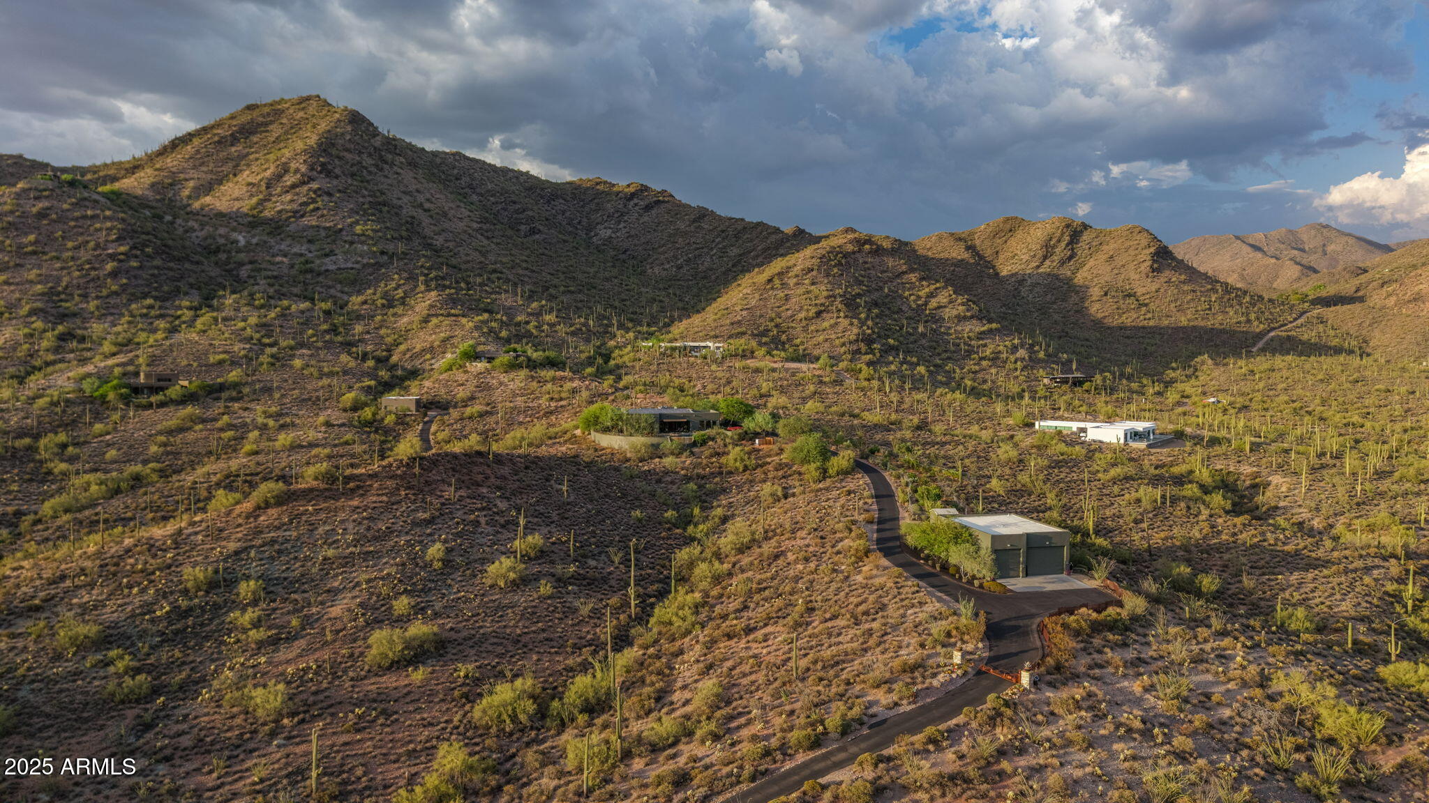 A true collector's dream, this gated Cottonwood Canyon retreat features a 2,050 SF garage designed for 2 RVs or up to 12 cars - a rare find in the Cave Creek luxury market. Perched high in the mountains and blending seamlessly with the desert, the home offers unmatched privacy, endless natural beauty, and dramatic views of sunsets, twinkling city lights, and rugged mountain vistas.
Designed for effortless indoor-outdoor living, walls of windows frame the ever-changing scenery while expansive patios and a negative-edge pool create the perfect backdrop for entertaining, stargazing, or quiet desert evenings.
Beautifully renovated and impeccably maintained, the home combines timeless design with modern efficiency, including solar power, a backup generator, and quality updates throughout. The open Great room centers around a chef's Kitchen, dining options, aside a stunning Office, and a welcoming Library/Game room with custom bar. 3 en-suite Bedrooms provide privacy for all.
Set on 4.5 acres with additional land available, this one-of-a-kind property is surrounded by towering saguaros, abundant wildlife, and the cool elevations of the high desert. Inspiring, functional, and private - this is an extraordinary opportunity in the mountains by Scottsdale, Cave Creek, and Carefree.

Please view more of the Quality Features in Documents tab.