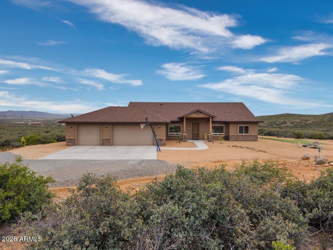 Enjoy breathtaking panoramic views from the Edgewood Construction home in The Estates at Cherry Ridge! This thoughtfully deisgned split floor plan offers an open great room that flows seamlessly into the kitchen - ideal for everyday living and entertaining. The kitchen features stainless steel KitchenAid appliances, granite countertops, and raised panel knotty alder cabinetry. The spacious primary suite is positioned privately and includes a large view window and an ensuite bath with soaking tub, walk-in shower, and generous closet. A versatile office can easily serve as a 4th bedroom. Additional highlights include a productive private well, engergy-efficient insulation and HVAC system, synthetic stucco exterior, gas fireplace, oversized 3-car garage, RV parking, and a fenced backyard.