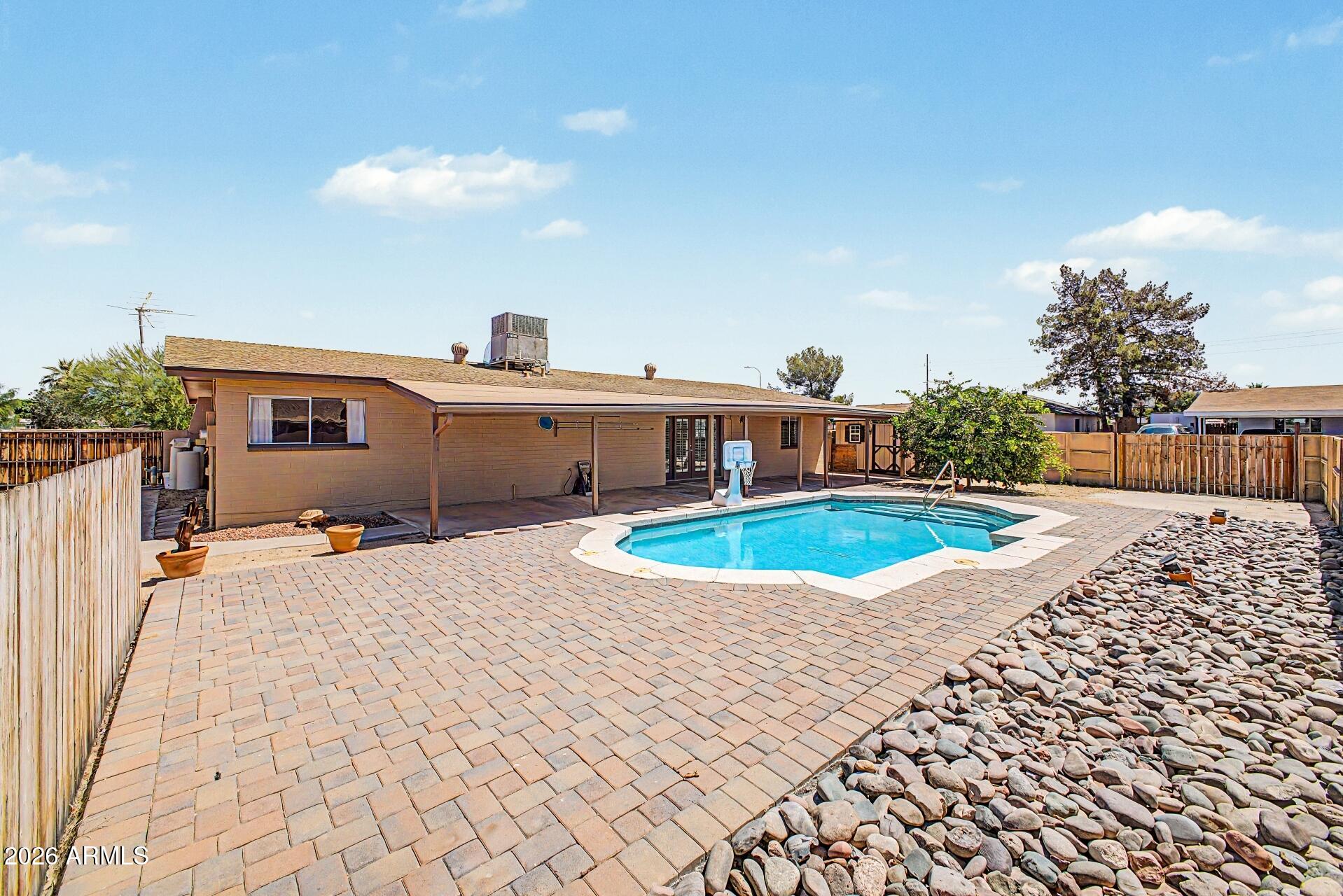 Beautiful home on large corner lot, no HOA, RV parking and a heated pool! Spacious floor plan with 3 bedrooms, 2 bathrooms and 2-car garage. Enjoy tile flooring throughout, ample hickory cabinetry and all appliances included. Large tiled shower in primary bathroom too.  The French doors lead to a huge full length covered back patio, perfect for relaxing or entertaining. Additional highlights include two RV gates with RV parking, large storage shed and sparkling pool just in time for summer fun!