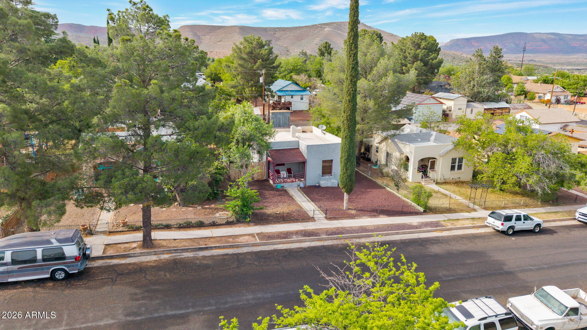 NEW PRICE!!! Come check out this historic home in Upper Clarkdale. This 2-bedroom 1 bathroom bungalow boasts historic Clarkdale charm with modern updates including an open floor plan from the kitchen to living room, updated flooring, countertops and large breakfast bar. The home also features newer windows in most rooms and an updated bathroom. Primary bedroom features a walk-in closet, while the laundry room offers plenty of storage and a large utility sink. Landscaping is adorable and backyard features a 1 car carport + plenty of additional parking. The 12x20 shed includes a ceiling fan and 120v electricity. In addition, there is RV parking in back too. Come experience what life used to like by sitting on the front porch sipping coffee and waiving to neighbors walking by !