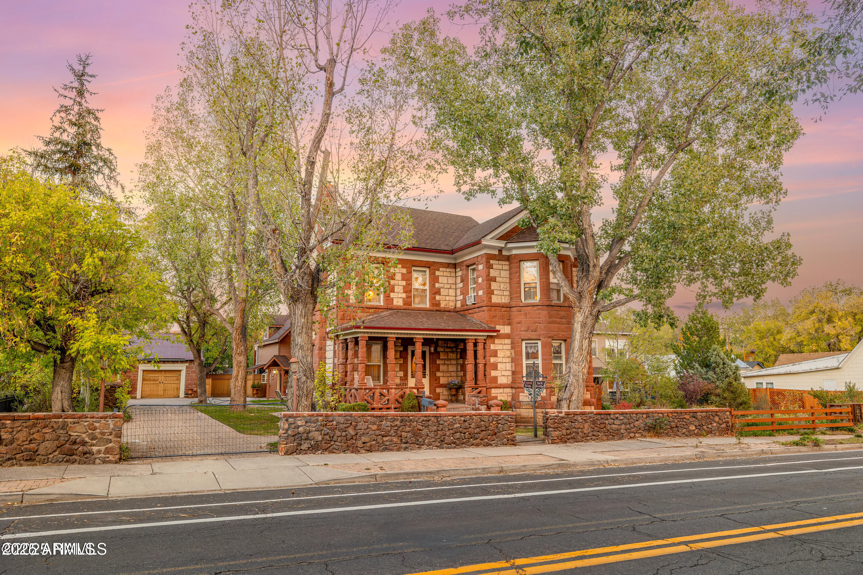 Just off the heart of historic downtown Flagstaff, the England House has stood for over a century as a symbol of craftsmanship, care, and quiet beauty. Built in 1902 by the England family, this two-story Victorian home glows with locally quarried red sandstone and the kind of character that can't be recreated today. Inside, every corner tells a story — pressed-tin ceilings, handcrafted wood details, and rooms filled with light and history. The main house offers five bedrooms and five baths, while just beyond its doors lies a private courtyard, shaded and fully enclosed, leading to a second home with two bedrooms, two baths, a loft, and modern comforts. Together, the homes form a peaceful retreat in the center of town - perfect for extended family, guests, or simply
enjoying space and privacy in one of Flagstaff's most beloved neighborhoods. Furnishings may convey at buyer's discretion.
Rarely does a home with such heritage, heart, and opportunity come to market. The England House isn't just a home  it's a piece of Flagstaff's story, lovingly cared for and ready for its next chapter.