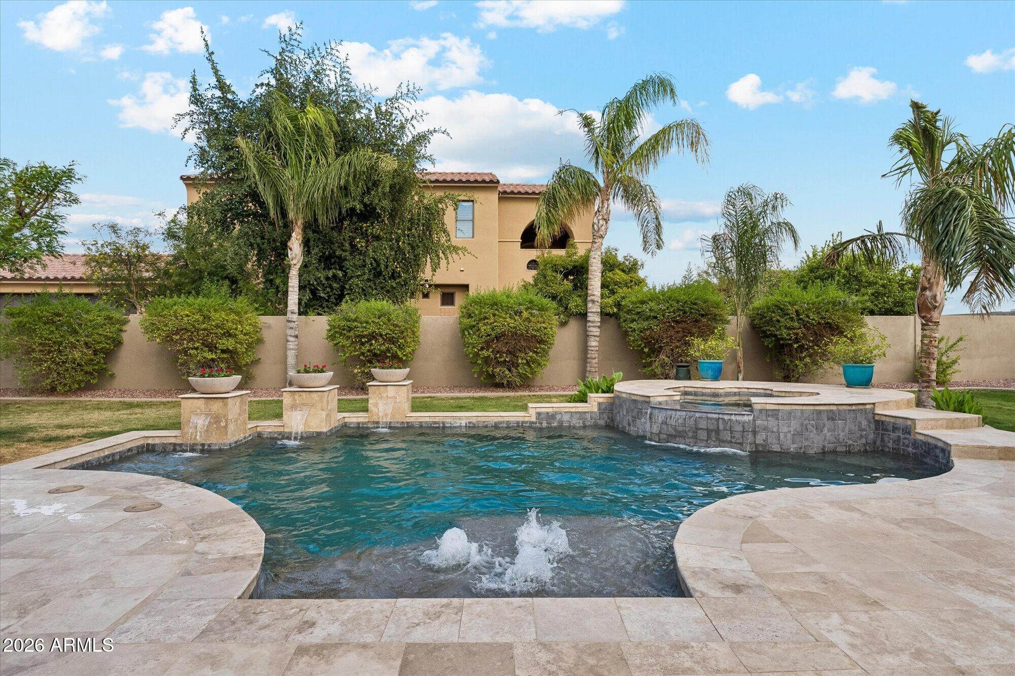 Luxury CUSTOM Home WITH RV GARAGE in WHITEWING AT KRUEGER. Properties with RV Garages rarely come up for sale. The details of this home surpass new construction. Upon entering through the custom iron/glass door one is greeted with an EXPANSIVE 24 FOOT TALL CEILING in the family room that looks through PANORAMIC WINDOWS showcasing the resort caliber pool. The details of the customized COFFERED BOX family room ceiling create a dramatic effect highlighted by the WOOD/STONE ENTERTAINMENT WALL. The mixture of textures and materials elevate the home. The KITCHEN was RENOVATED in 2023 with luxury in mind. Tired of Grey and White? This kitchen features AFRICAN ZEBRAWOOD CABINETS, KitchenAid appliances including a built-in refrigerator, pot filler, subway backsplash, and granite countertops. There is bamboo wood laid on the diagonal to highlight the space. The undercabinet lighting is elevated by the BACKLIT REVERSE COFFERED CEILING. Relax in the owner's suite equipped with cork floors, its own laundry, a private sitting area and fireplace. The owner's suite has private balconies off the front and rear of the home looking out over the pool. Outside there is a travertine patio with fireplace and built in BBQ. Enjoy the ambiance the pebble-tec pool and spa provide with the bubblers and spillways. You'll enjoy the citrus trees which include grapefruit, peach, orange, and plum alongside an exterior shower. The AC units have all been replaced in the past 5 years. The RV garage has its own clean-out and 240V and 50 AMP power along with a ½ bathroom. This is a unique property that will not last long.