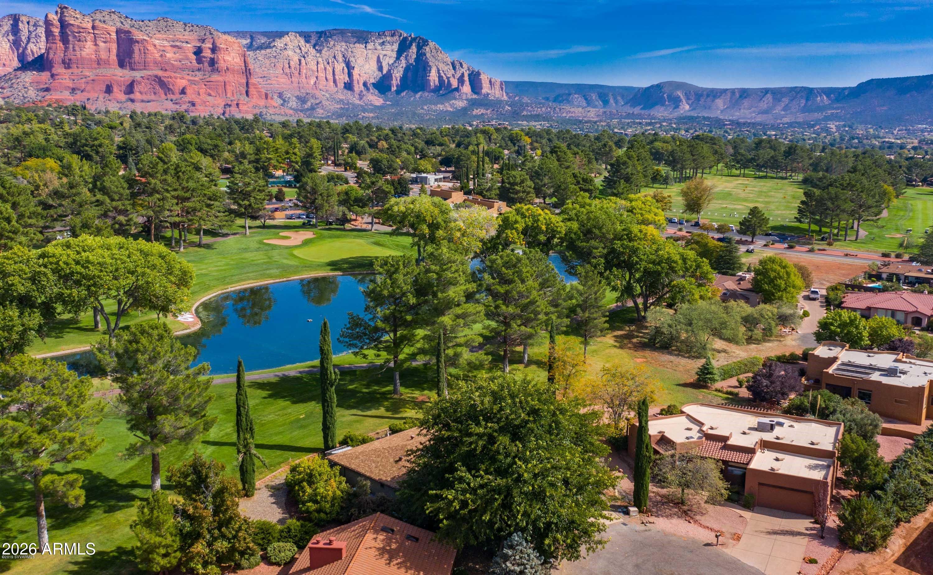 Experience a beautifully preserved golf course lifestyle in this immaculate, single-level Santa Fe-style residence. Perfectly nestled on a spacious, pie-shaped cul-de-sac lot, this home sits directly on the 10th hole of the Oak Creek Country Club. The property showcases panoramic Red Rock vistas sweeping from Castle Rock Range to Courthouse Butte and Bell Rock. Meticulously maintained in absolutely pristine condition by both the owner and long-term tenants, the spacious floor plan flows perfectly as an entertainer's delight. The great room features a double-sided natural gas fireplace and a convenient dry bar, opening into a generous granite-counter kitchen with a premium cooktop and peninsula setup.
No detail has been overlooked, with over $150,000 in recent capital updates. The exterior features fresh stucco and paint (2024). Recent mechanical and interior enhancements include a complete indoor paint job (2026), a brand-new water heater (2026), a fully serviced A/C unit (2026), and a newly serviced alternative septic system (2026). A fully compliant VOCA inspection (2026) offers immediate peace of mind. Additional interior accents include a private office with built-in cabinetry, elegant tray ceilings, skylights, a water softener, and a reverse osmosis filtration system.

Outdoor living thrives beneath deep covered patios with built-in seating, leading down to a hidden garden sanctuary framed by flowering trees. The oversized, 600-square-foot garage easily accommodates two large vehicles plus a personal golf cart. Country club amenities like the clubhouse, tennis, pickleball, and dining are just steps away. 

Seller may consider flexible, short-term owner financing structures for well-qualified buyers. 
Property is tenant-occupied; active smart security cameras are on-site. Tenant's beautiful furnishings may be available for separate purchase directly from the tenant via a separate bill of sale outside of escrow.