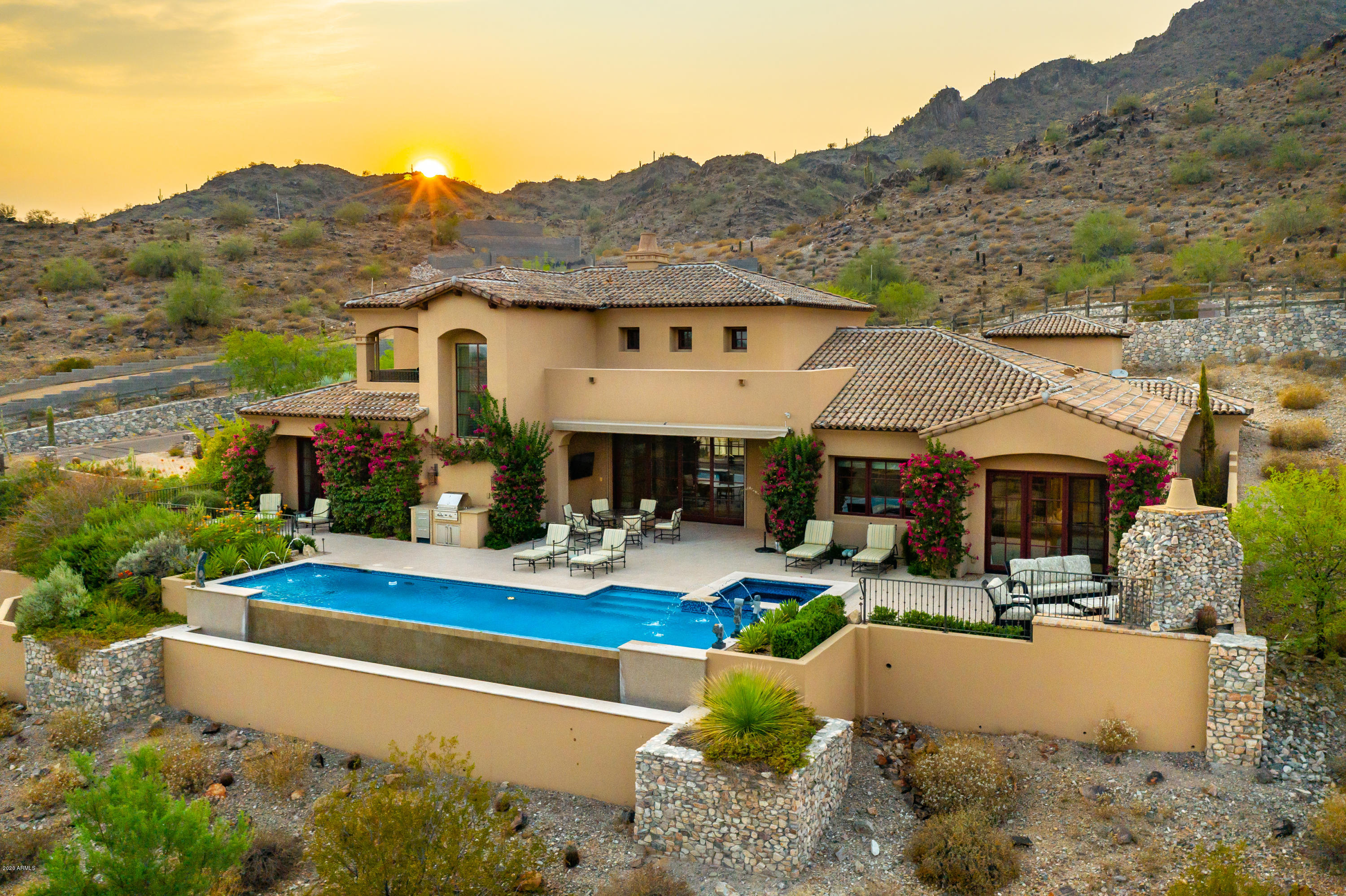 This custom luxury residence, built in 2013 by Cullum Homes, offers amazing Camelback Mountain Views with the master bedroom on the main floor! Just reduced by $500,000, what an incredible price. The over sized three-car air-controlled garage, allows room for your priceless toys! Home features DuChateau oak wood floors. The open concept features soaring wood-beamed ceilings and clerestory windows, while the gourmet kitchen is adorned with custom cabinetry,  granite center island, and Wolf/SubZero appliances. The bedrooms, kitchen and formal living room are on the main floor, while the second level features a spacious lounge/family room with an over-sized patio looking out to Camelback Mountain. The master retreat is the ideal sanctuary with a impressive en-suite, complete with a soaking tub, marble slab shower, dual vanities with light-up counter, and a walk-in closet fit for royalty. Outside, enjoy your infinity-edge pool, spa, outdoor fireplace, built-in grill, and stunning mountain views. The list of amenities and delights is endless with this home, so call today for your private showing!