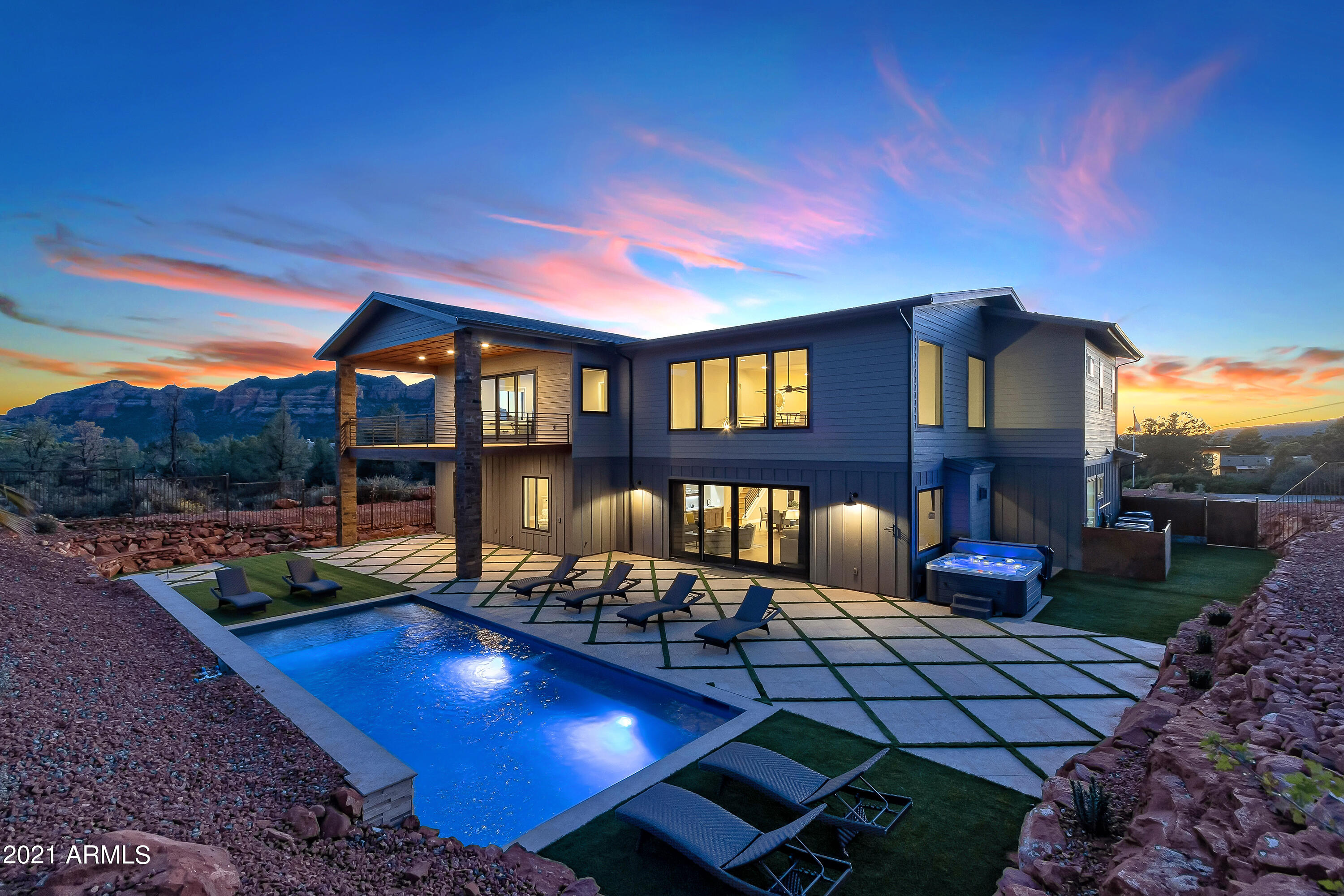 NEW CONSTRUCTION! Current bookings at $2362/NIGHT. Suite Retreat w/ IDYLLIC RED ROCK VIEWS! Furnished & Turn Key Ready- NO HOA- STRs Allowed. 6622 sq ft, 7 Master Suites, Great Room, Game Room, Media Room, elevator, office, Heated Pool, Hot Tub, 3 car garage on over Â½ an acre Zeroscape lot. 5 Master Suites in Main House & 2 En-suites in guest casita over garage w/kitchenette, LR, DR & laundry. Clean lines w/ crisp white & greige paint, textures of wood & tile,  interior connection w/ outdoors via multiple patios & windows. Jawdropping Gourmet kitchen delights w Gas Wolfe range, Electric oven, Bosch Wifi Fridge, Asko Dishwasher, Cambria  counters, & a Cambria/ Walnut Butcher Block Combo island w/wine fridge that provides a nice transition between great room space & kitchen & can serve as a buffet.  
22 ft ceilings in LR & DR table to serve 14. Wet bar at Great Room w/ Scotsman icemaker and sink. Each master suite in main house offers private Electrolux fireplace & mounted big screen TV. Game room ready for billiards, shuffleboard & Sunday Football. Upstairs flex room ideal as media room w/ ping pong table and wine fridge. Main Utility room equipped with 2 sets of front load washer & dryers & extra Galanz Fridge. U Shaped Paver Driveway for ample parking and low maintenance landscaping front and back. Backyard fully fenced w/ turf and stone design, heated pool, hot tub with mineral stick ( change 1x every 4 mths), covered patio, open patio spaces, plumbed for outdoor firepit and outdoor BBQ. Energy efficient & sound reduction upgrades include: R-21 cellulose wall spray on both interior and exterior walls/ R-300 batts in floor & Ceiling. 5/8" drywall throughout w/RC Channel vibration reducer on interior walls. Anderson 100 series double pane composite windows throughout & Heritage Smooth 1 3/8" solid core interior doors throughout. Smart home componentry consists of: wifi enabled wave 2 wireless ceiling mount access points, Honeywell thermostats, landscape timers, Feit entry & exterior light dimmers, Reolink security cameras & structured wiring smart panels. 5 Trane High efficient #XR17 (17 Seer Heat Pumps) w/ 5 Trane High efficient #TEM6 Air Handlers ( 3 horizon units in attic / 2 vertical units in mechanical room). 2 High efficiency 75 gallon Hot water Heaters, recirculation pump, adjustable pressure regulator on hot water heaters, water filtration system, and soft water. Keyless locks on front door, elevator, garage and casita. 11 Big Screen TV's &  8 fireplaces throughout ( 2 gas and 6 electric). Furniture package upgraded to a care package ( so if there is a spill, Living Spaces will replace the furnishings for up to 3 years). 1000 gallon OWNED propane tank ( propane for range, great room fireplace, media room fireplace). TESLA charger in garage. Lights, thermostats, pool, and cameras can be programmed on your cell phone. Every detail thought out to the 10's.  A true delight to the senses! The perfect RETREAT For extended family, corporate retreat, STR's, Senior Couple Living- The possibilities are endless. A MUST SEE TO APPRECIATE.