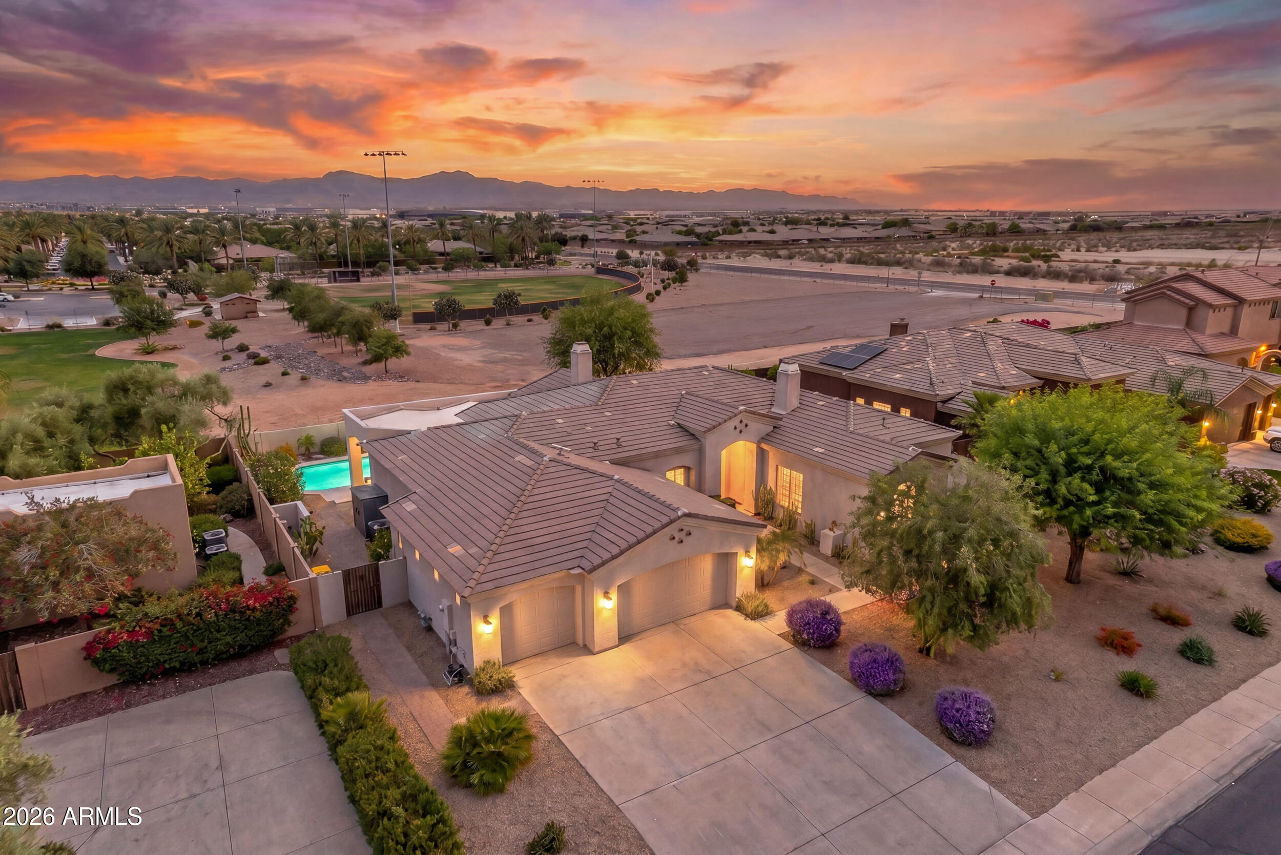 Nestled in the prestigious, gated community of Litchfield Greens, this breathtaking 2,715-square-foot estate exemplifies desert luxury and meticulous care. From
the moment you step inside, you are greeted by soaring ceilings, abundant natural light, and new ceramic wood-look tile flooring that flows seamlessly through
the formal dining room, separate living room, and open great room, with ceiling fans installed throughout for optimal year-round comfort. The gourmet kitchen is
a chef's dream, featuring freshly painted staggered white cabinets, premium granite countertops with a stunning tile backsplash, a classic farmhouse sink, a
central island, a breakfast nook, and top-tier, newer matching KitchenAid appliances complete with a gas cooktop. Elegant wood shutters throughout the home ad Elegant wood shutters throughout the home add a timeless touch of sophistication, leading you to the private master split retreat, which boasts a spacious en-suite bath with a relaxing jacuzzi tub. Along with the 3 large bedrooms and 2.5 bathrooms, the home includes a spacious den with a separate entrance, perfect for a home office, guest suite, or studio.
Step outside into your private, 11,627-square-foot sanctuary, where you will enjoy complete privacy with no neighbors behind you. The expansive backyard is a rare desert find, offering lush landscaping with real grass and thriving lemon, lime, and orange trees for fresh citrus. Entertainment options abound with a cozy gas firepit and a sparkling pool that was recently refreshed with new decking and pristine Pebble Tech finish, making it the ultimate spot to take in the breathtaking Arizona sunsets and majestic mountain views. Major high-ticket upgrades provide ultimate peace of mind, including a new roof installed in 2021, fresh exterior and interior paint, and an extended 3-car garage outfitted with brand-new epoxy flooring. This turn-key masterpiece perfectly combines a luxurious, private lifestyle with an enviable location just moments away from the legendary Wigwam Resort golf courses.