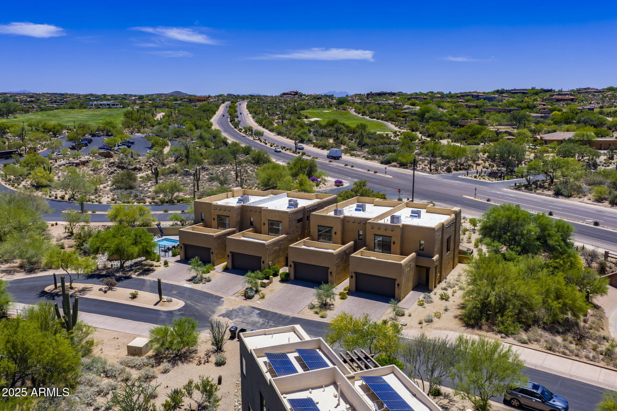 Rare Resort-Zoned Investment Opportunity in Troon North! Welcome to 10299 E White Feather Ln. an exceptional 0.67-acre estate offering rare resort zoning and outstanding short-term rental potential just steps from Troon North Golf Club. This unique property includes two buildings, each with two fully furnished luxury villas, totalling 4 high-end units and over 12,228 sq ft of combined indoor/outdoor living space. Each two-story villa features 3 spacious bedrooms, 3.5 spa-like bathrooms, a private 2-car garage, and modern interiors with premium finishes throughout. Located just 138 yards from the clubhouse, this is one of the few properties in Troon North with short-term rental allowances. An unparalleled opportunity for investors or those seeking a luxury multi-unit retreat. This property is one of only two in the Troon area with resort zoning, allowing short-term rental operationsa rare and highly valuable asset in this upscale community. Outside, guests enjoy a shared resort-style backyard complete with:Heated pool & spa, Synthetic turf putting green, Two cozy fire pits, Outdoor BBQs and multiple lounge areas.Whether catering to golf lovers, luxury vacationers, or event guests, this turnkey estate delivers exceptional appeal and consistent income potential.