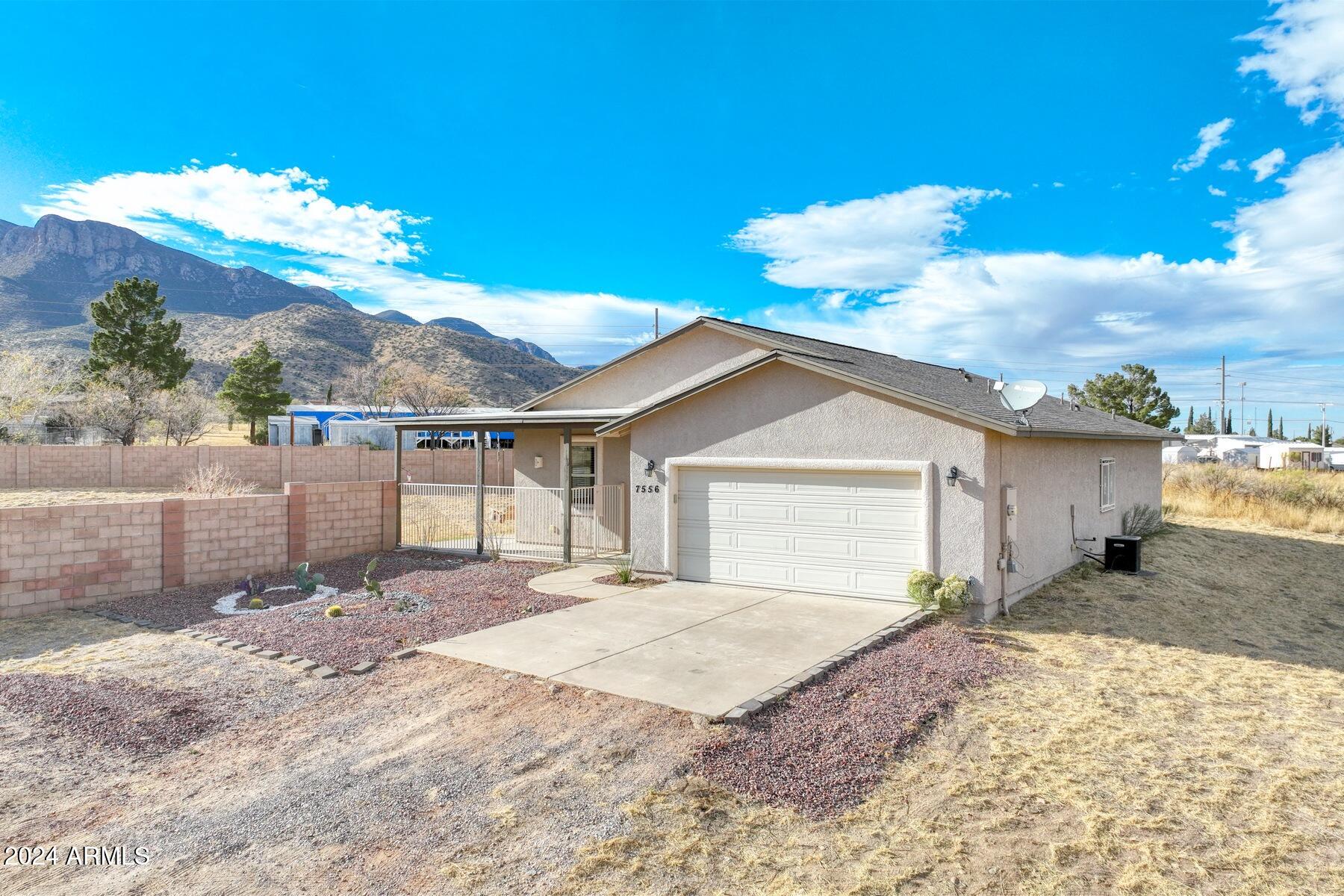 Beautiful 1-acre elevated lot with breathtaking views of the Huachuca Mountains! This 1,738 sq. ft. all-electric home features 3 spacious bedrooms, 2 baths, and an open floor plan with no carpet. Enjoy natural light from abundant windows, large bedrooms, and a wraparound patio. The fully fenced backyard boasts a block wall, 2 RV gates, and natural Arizona grass, while the front yard is low-maintenance gravel. Includes a 30-amp RV outlet—perfect for adventure enthusiasts! Conveniently located minutes from shopping and surrounded by endless hiking opportunities.