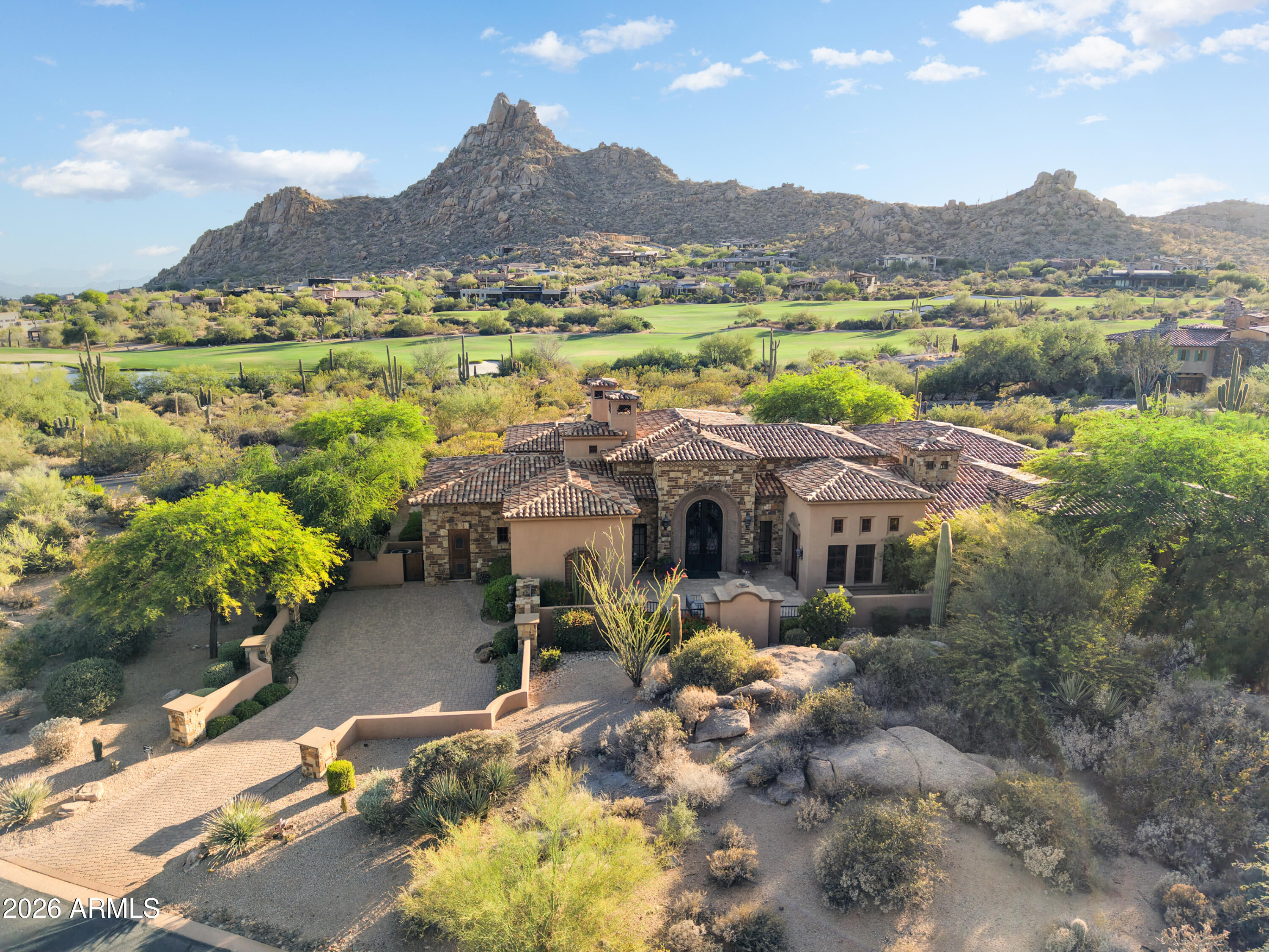 Estancia Golf membership opportunity. Elegant old world style home with panoramic views of Pinnacle Peak. Three bedrooms plus an office and a great room floor plan with zero interior steps. The outdoor living includes a covered loggia area, dedicated spa and heated pool, outdoor kitchen with BBQ station and Traeger grill plus a fire pit seating area. Crestron home automation and a three car garage complete the residence.