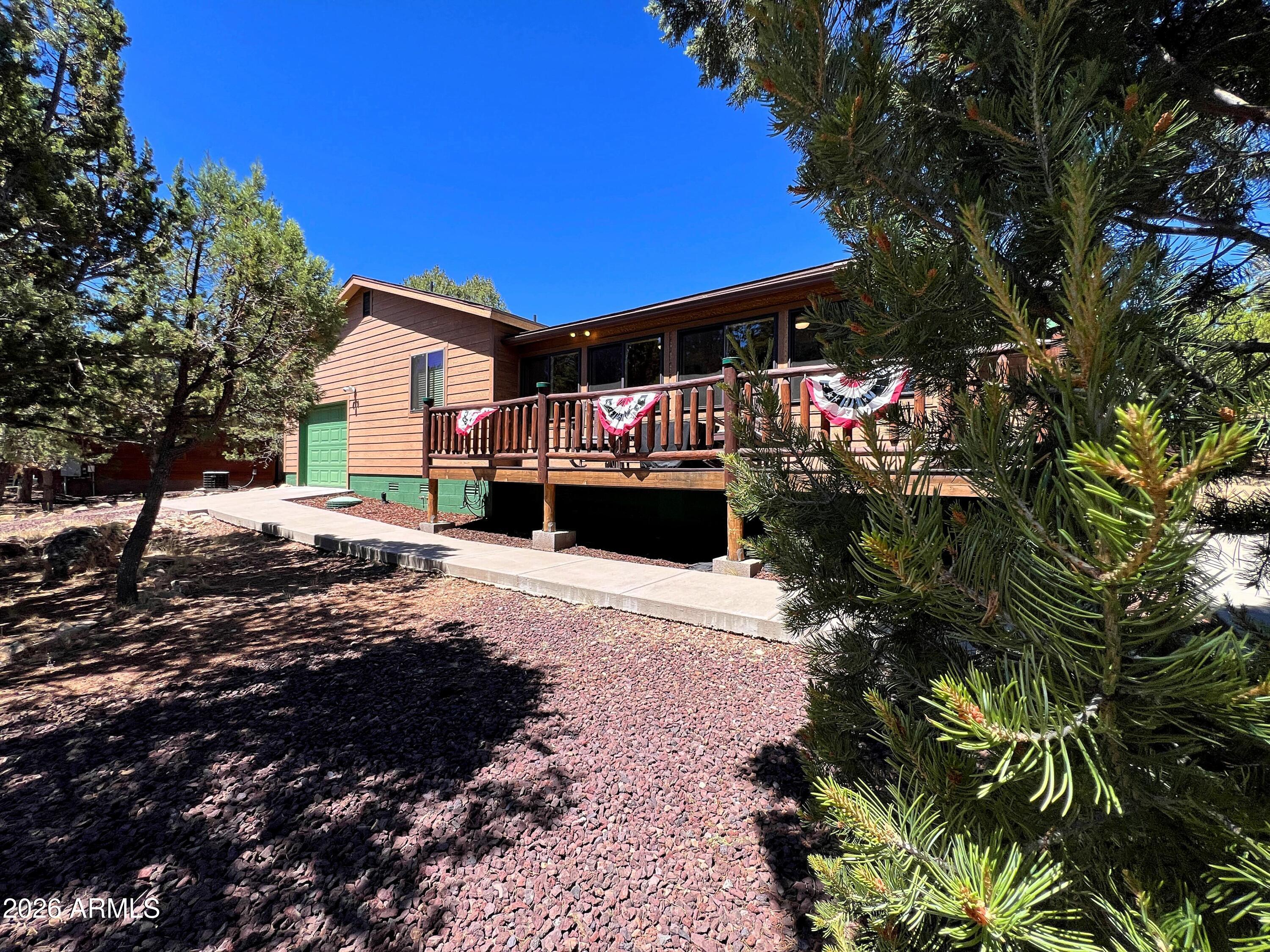 Escape the heat and discover your mountain retreat! Sold mostly furnished and offered BELOW RECENT APPRAISAL, this beautifully updated cabin sits on a peaceful .36-acre lot surrounded by trees on the outskirts of Heber, just over 2 hours from the Valley. Enjoy coffee on the Trex front deck, relax in the enclosed sunroom as wildlife wanders by, or gather around the stunning stone fireplace after a day exploring 1000s of miles of nearby National Forest. Quality finishes include low-maintenance composite siding, T&G pine accents, knotty hickory cabinetry, quartz countertops, updated flooring, a newer roof, and a high-efficiency Lennox HVAC system. The tandem two-car garage offers plenty of space for vehicles, ATVs, and outdoor gear. Stop waiting and start enjoying your mountain getaway!