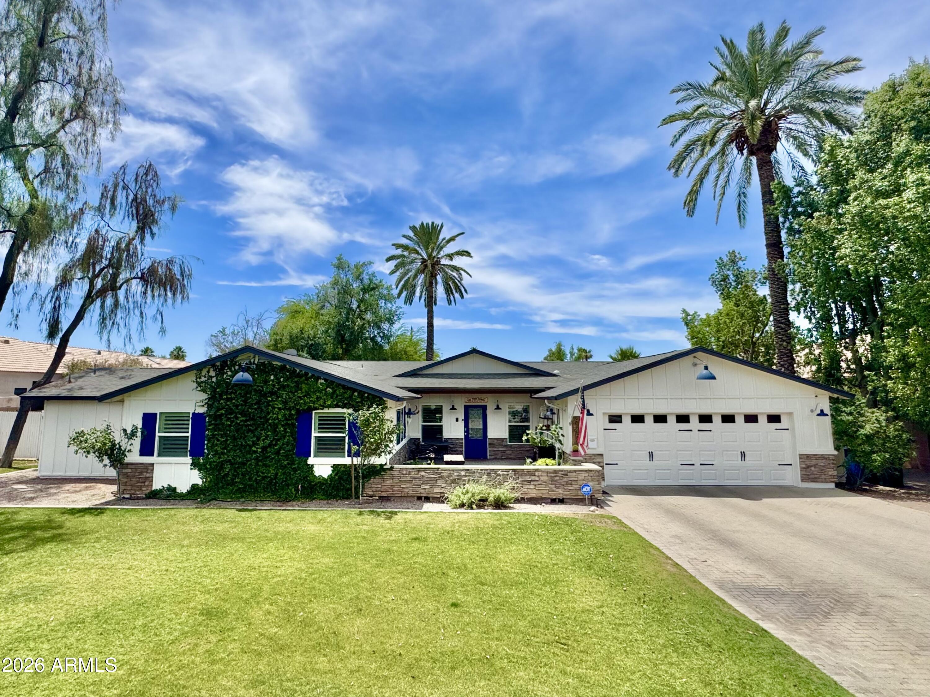 Dreaming of the ultimate backyard? The kind everyone wants to gather in? This is it.  Hidden behind a lush ficus hedge with a long private paver driveway, this special property feels like a secluded retreat from the moment you arrive. Sitting on nearly 28,000 square feet, the oversized lot offers an incredible amount of usable outdoor space with sprawling green grass, mature landscaping, raised garden beds, a charming chicken coop, and room to truly live.  The sparkling saltwater pebble-sheen pool with water feature, gas firepit, and expansive covered patio create the perfect setting for entertaining, relaxing, or enjoying Arizona evenings under the stars. Guest house plans have already been completed, offering exciting future potential.  Inside, the 3,000+ square foot home is bright, open and full of warmth. Newly installed wide plank natural oak wood flooring runs throughout, bringing a clean organic feel to the entire home. The white and stainless kitchen features abundant prep space, a dream walk-in pantry, quality appliances, and beautiful views overlooking the lush green backyard. The spacious primary suite offers a true retreat feel, while the home's open layout, natural light, and timeless charm make every space feel welcoming and connected to the incredible grounds outside.  With four bedrooms, three full baths, and one of the most special yards you will find, this home perfectly blends comfort, privacy, and unforgettable indoor-outdoor living.