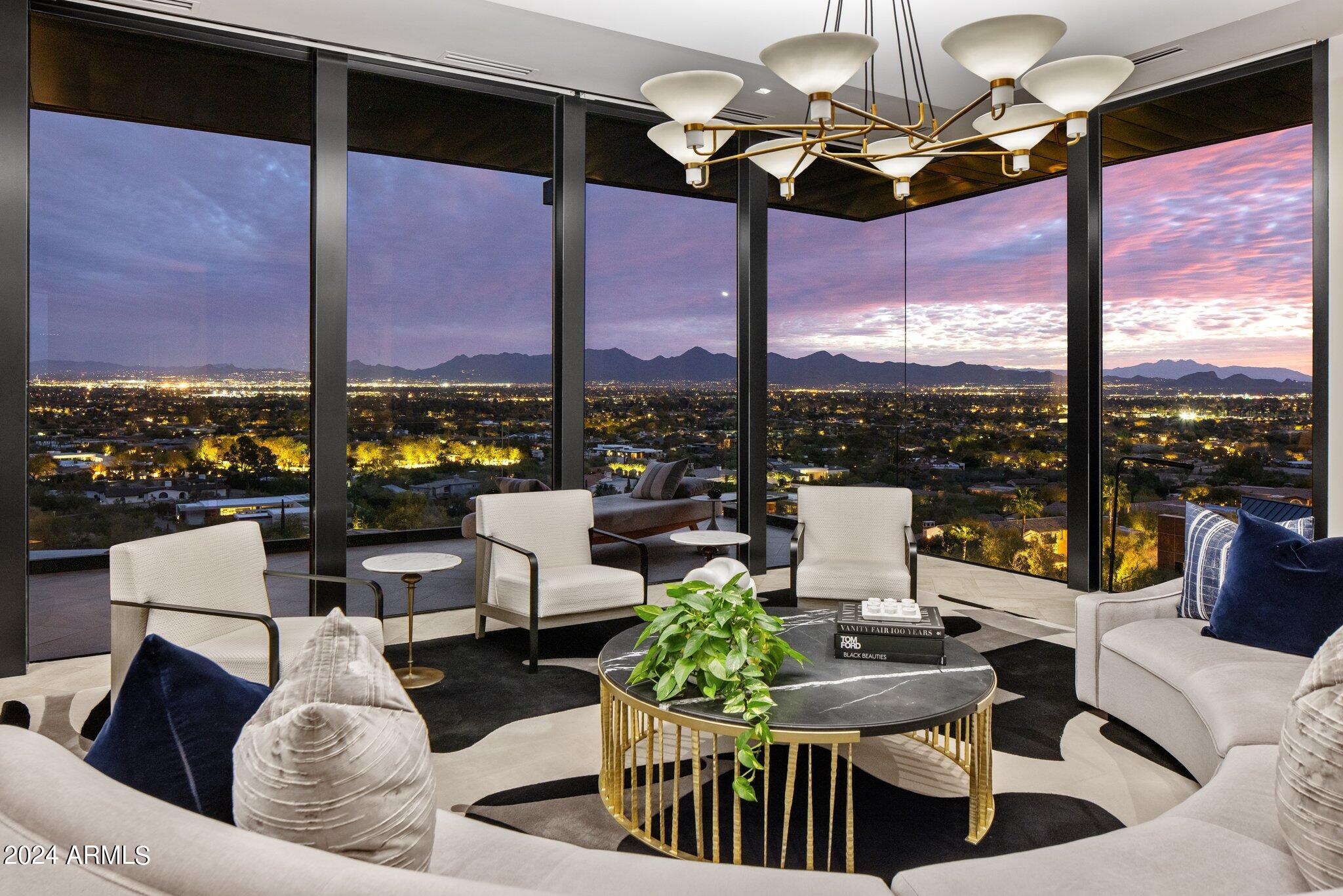 This SIGNATURE property lives like a contemporary mountain penthouse & has been meticulously crafted to integrate all essential living spaces onto the main level! Experience sweeping city light & mountain vistas from every angle through multiple retractable glass walls opening to several terraces, including an iconic cantilevered peninsula terrace that floats above the heated lap pool. Relish in diverse dining scenes from the indoor dining room to the intimate alfresco patio w/ a BBQ & pizza oven or choose to enjoy dining from the sky view terrace! Luxury amenities include a spa-like primary suite, dual walk-in closets, sleek kitchen, dedicated media/family room, guest suites w/ their own kitchen & captivating conversation room, gym, an office, and a temp-controlled garage, wired for EVs! An impressive pedigree of high design from Architects Allen + Philp Partners, interior design by Jamie Herzlinger Interiors and remodel performed by Greg Hunt.

This remarkable estate has been reimagined & redesigned by the same visionary minds who developed the Sanctuary Resort & Spa, Mountain Shadows Resort, and the Hotel Valley Ho!

Positioned high on Mummy Mountain yet located within minutes of Scottsdale Road offering access to exciting entertainment venues, world-class restaurants, destination resorts and luxury shopping.