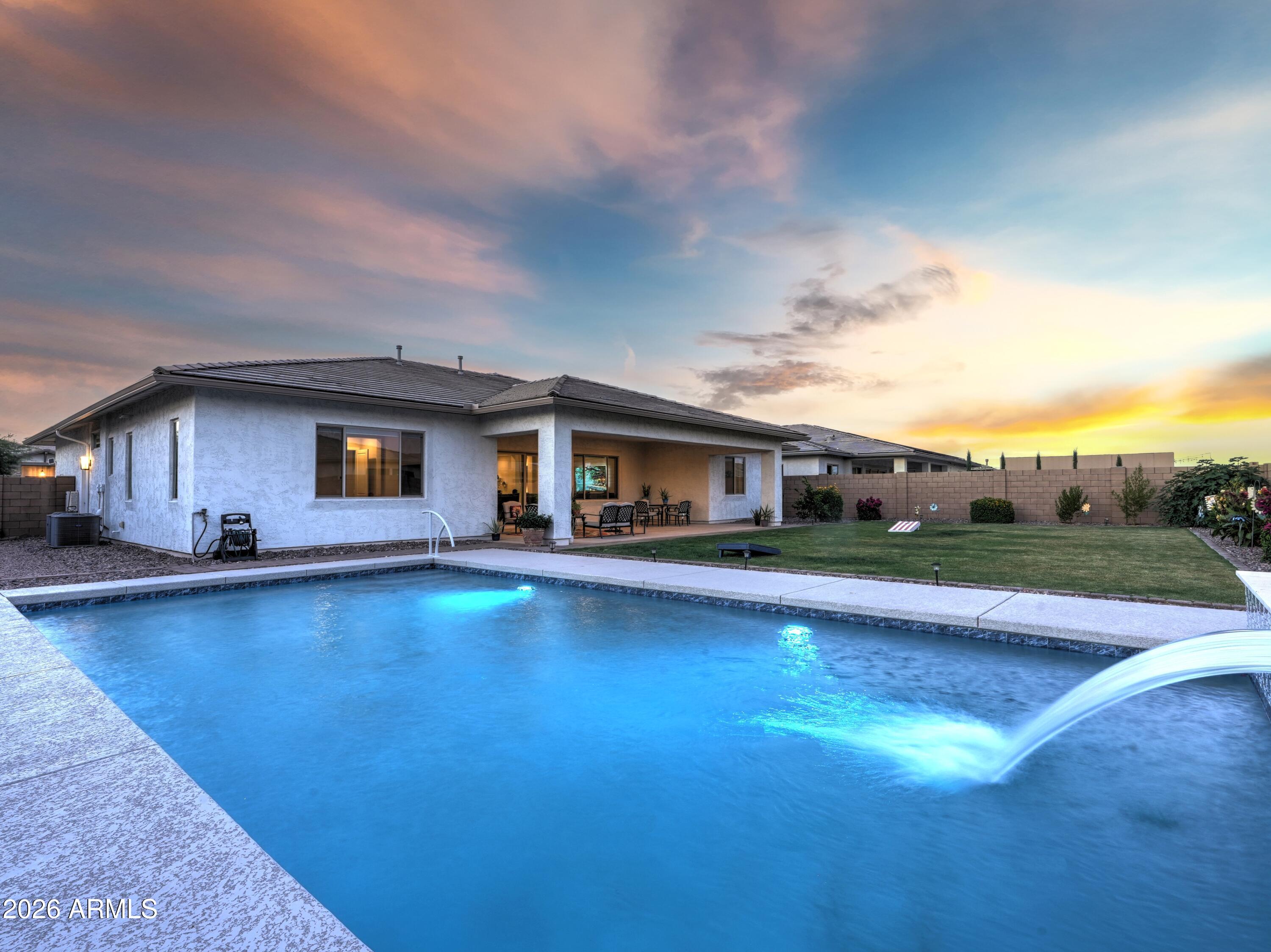 Welcome to the luxurious Heritage Collection at Meridian, a master-planned community known for its amazing outdoor amenities, location adjacent to the Queen Creek wash trail for hiking, biking, & equestrian use, several nearby golf courses, & close proximity to shopping, restaurants, & entertainment at popular destinations like the Olive Mill, Schnepf Farms, & everything downtown Queen Creek!

This 4 BD, 3.5 BA single-level home expands over 3600 SF & seamlessly features open-concept living, two additional bonus rooms, a split 3 car garage, an oversized lot complete with pool, carefully landscaped yard space, extended covered patio for relaxation or entertainment, and over $100K in upgraded features. Inside the home, there is wood-look plank tile flooring & two-tone interior paint throughout, neutral carpeting in secondary bedrooms, a tankless water heater, white quartz countertops & a chef's kitchen with soft water system and reverse osmosis, gourmet GE S/S appliances, gas range, double ovens, tile backsplash, upgraded cabinets, pendant & under-cabinet lighting, a butler's pantry, & a massive walk-through pantry. An expansive laundry room already pre-plumbed for a sink, offers separate home access to the single car garage & plenty of storage.  

Featuring separate space for an office & formal living or dining, a large family room open to the gorgeous kitchen & covered patio through multi-slider doors, split bedrooms which include a primary suite along one side with its own private patio access, en-suite bath including double vanities & make-up station, free-standing Kohler tub, large tiled walk-in shower, & oversized walk-in closet, this home shows thoughtfully curated attention for the most sophisticated buyer. Three additional bedrooms with large walk-in closets, including one with its own private en-suite bath, incorporate the other wing of the home to give plenty of peace & privacy for guests. 

The backyard oasis is move-in ready while still offering ample opportunity for custom additions to suit your personal wants and needs. Situated on an approx. 13,371 SF lot, the thoughtfully landscaped backyard features a newer-constructed pool complete with water features and relaxing therapy jets, creating the perfect balance of luxury and tranquility. Designed with both entertaining and everyday respite in mind, this outdoor retreat offers an exceptional setting to gather, unwind, and enjoy Arizona living at its finest. Located only 8.5 MI from Phoenix-Mesa Gateway Airport, 6 MI from SR24, 4.9 MI from Queen Creek Marketplace, & 36.7 MI from Sky Harbor Airport, this opportunity will NOT last long! See this gorgeous property for yourself & make an offer before it's GONE!!!!