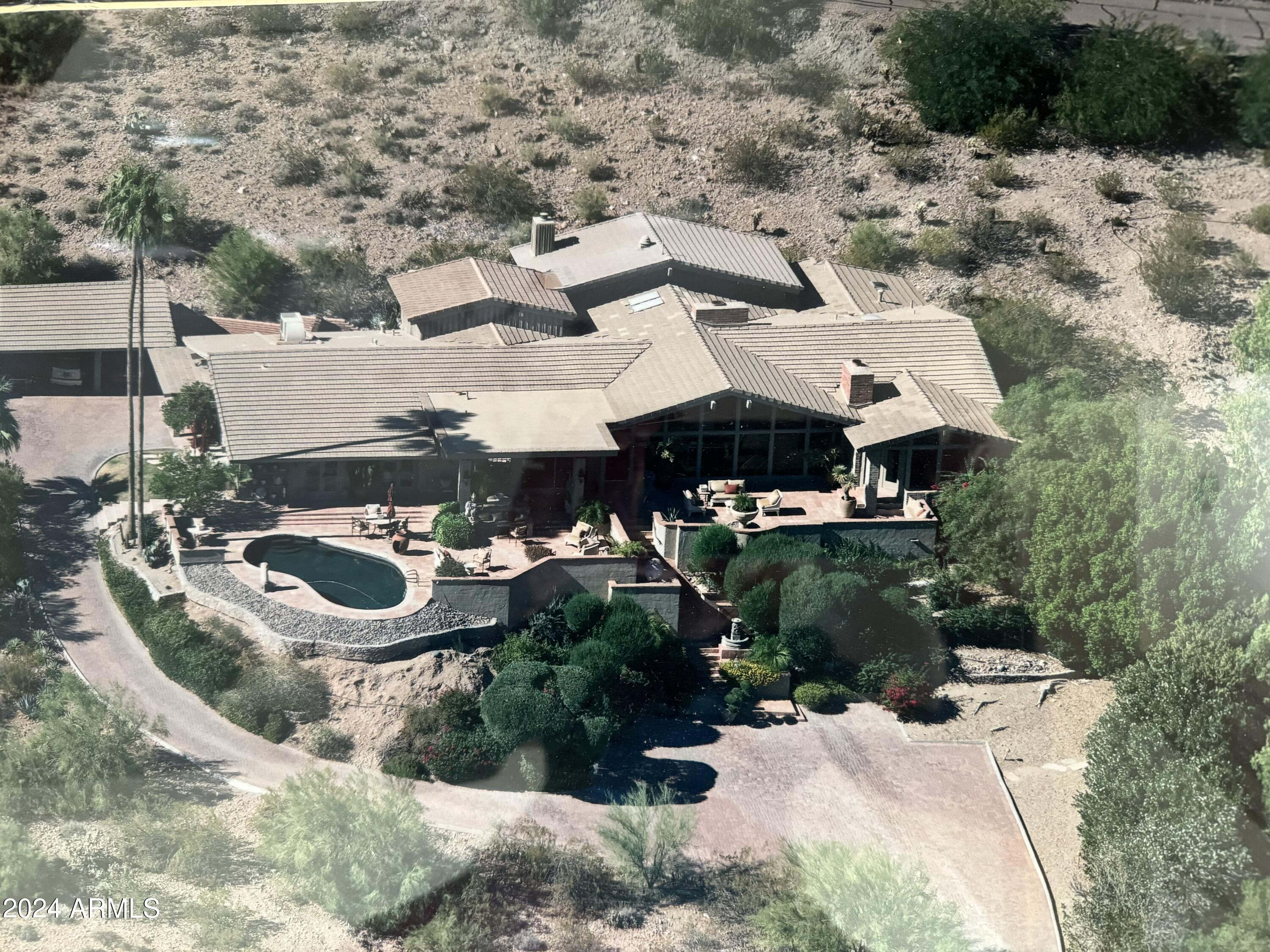 Imagine full, unobstructed Camelback Mountain views (tail to nose) from this expansive hillside lot in Paradise Valley with a view from Four Peaks to South Mountain. This lot takes full advantage of the changing colors of the Camelback and Mummy Mountains and views of the front nine golf course at Paradise Valley Country Club. Remodel or, better yet, create your own paradise perched overlooking Paradise Valley. Sunrises, moonrises, watching fireworks around the Valley and the landing lights of planes coming to Sky Harbor are all intangibles that add immense value to this property. It is sold as both a developable lot or a remodel. The house sits high on the lot by Moonlight Way with an opportunity for a casita on the lower portion by Sparkling Lane. This is truly the definition of Location, Location, Location. No-one will ever block the view from this private, elevated lot.