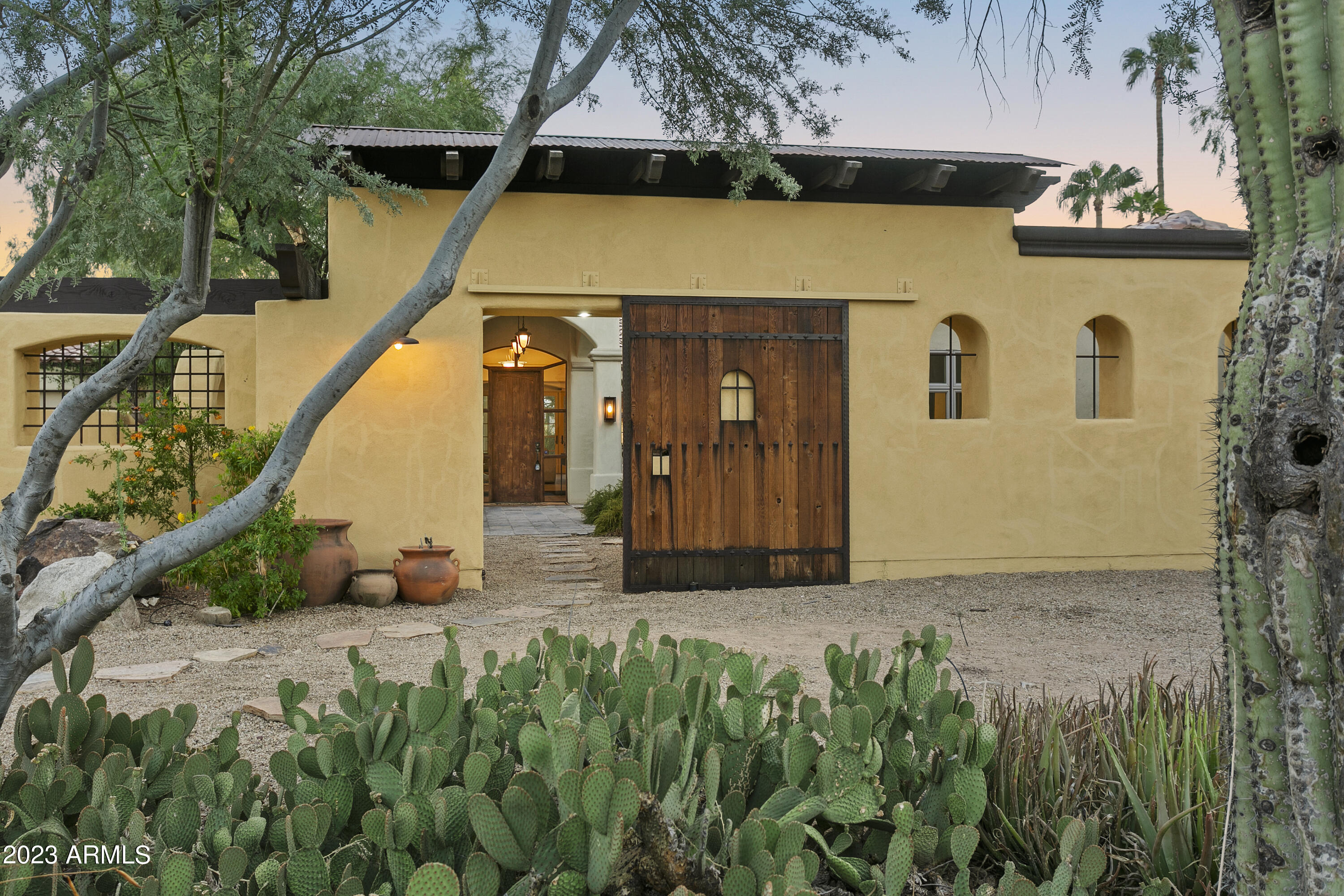 Introducing a classic Paradise Valley estate. Boasting 4,200 sq ft of living space, this property rests gracefully on over 1.3 acres of secluded tranquility on a prime flag lot. Hiding behind a private gate down a palm lined drive, the home offers the perfect blend of classic charm and modern comfort. 
With 4 spacious bedrooms and 4.5 baths, there's room for everyone. The master suite is a private oasis with a luxurious ensuite bath. A bright and open interior welcomes you with abundant natural light, highlighting the home's classic architectural features. 
The heart of the home is a chef's dream—a large kitchen with ample counter space and storage. Entertain effortlessly with the great room and oversized patio, or enjoy a casual night at home. Step outside to your own paradisea sprawling yard with mature landscaping, a refreshing pool, and fruit trees. Gather with loved ones under the shade of large trees or soak up the sun by the poolside. 
This property exudes classic Arizona charm. Don't miss the opportunity to make this dream home yours. It's a timeless treasure waiting for your personal touch. Welcome home to comfort and serenity.