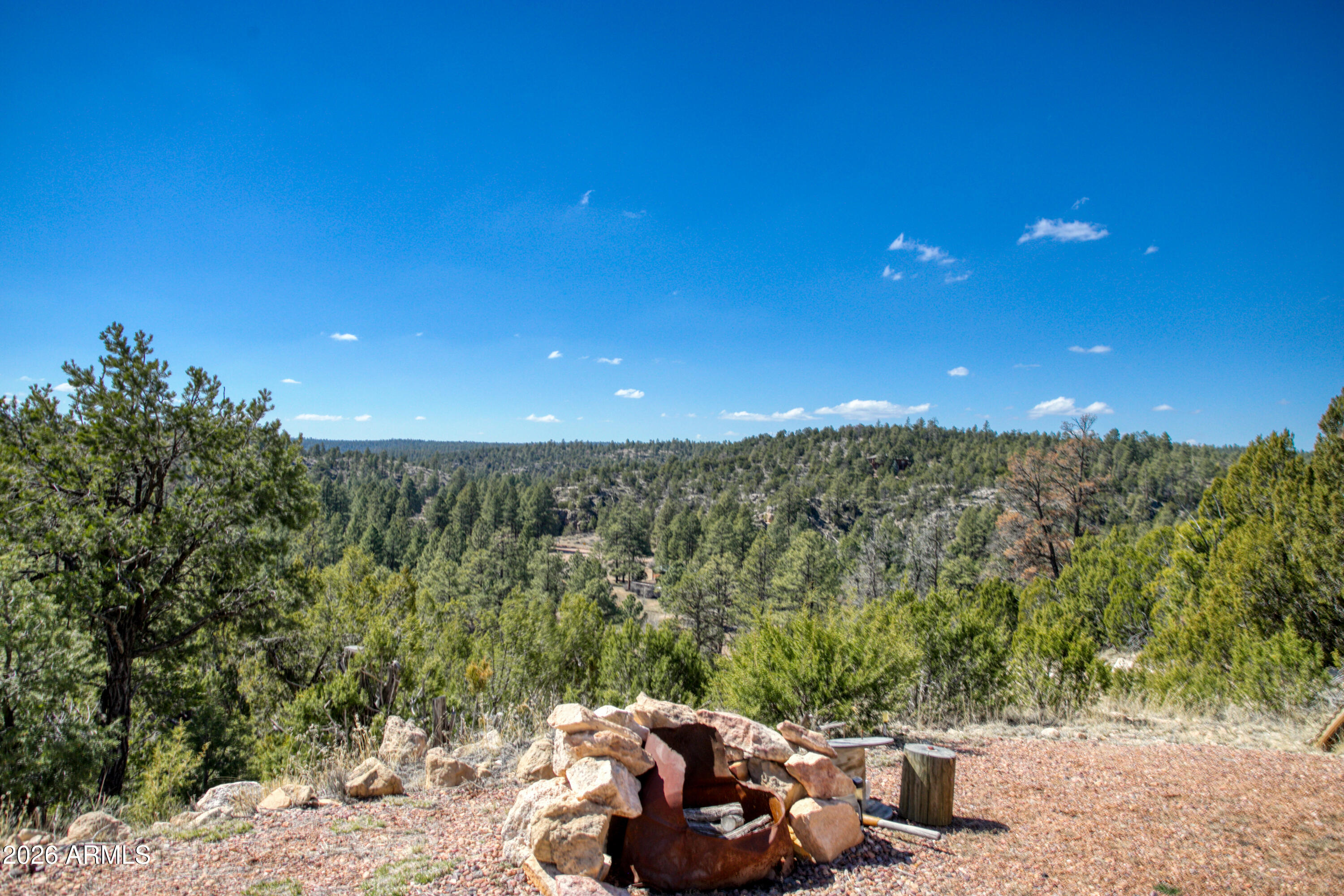 Unbelievable opportunity to own a 5-acre ridge-top parcel in Heber, AZ, offering panoramic canyon views and a fully turn-key setup in the heart of the White Mountains. This property sits atop a scenic ridgeline with a large, level building pad already in place, plus power, septic, and 700 gallons of total water storage (500-gallon buried tank + 200-gallon auxiliary tank). A second flat area at the bottom of the parcel provides additional space for a guest home, rental unit, or future build. No HOA and plenty of room for Multiple homes, horses, RVs, and all your mountain toys. Included in the sale is a 2022 Jayco Eagle 321RSTS fifth wheel, used fewer than 10 times and in excellent condition. Features include triple slide-outs, Climate Shield" zero-degree tested insulation, residential-style kitchen with 21 cu. ft. refrigerator, 4K Ultra HD Smart TV, fireplace, queen bedroom suite, and fully enclosed/heated underbelly--ideal for year-round mountain living. Fifth wheel sits on the main building pad and creates an immediate, comfortable living option.

Property also includes a storage shed with tools, water tanks with pump, and easy access from the Highway. Located in Heber, known for its cool summers, four seasons, and proximity to national forest, lakes, and outdoor recreation. This is a rare chance to secure improved acreage with utilities, views, and a ready-to-enjoy setup. So many possibilities--vacation retreat, full-time residence, or income-producing rental. Come see this exceptional White Mountain property today.