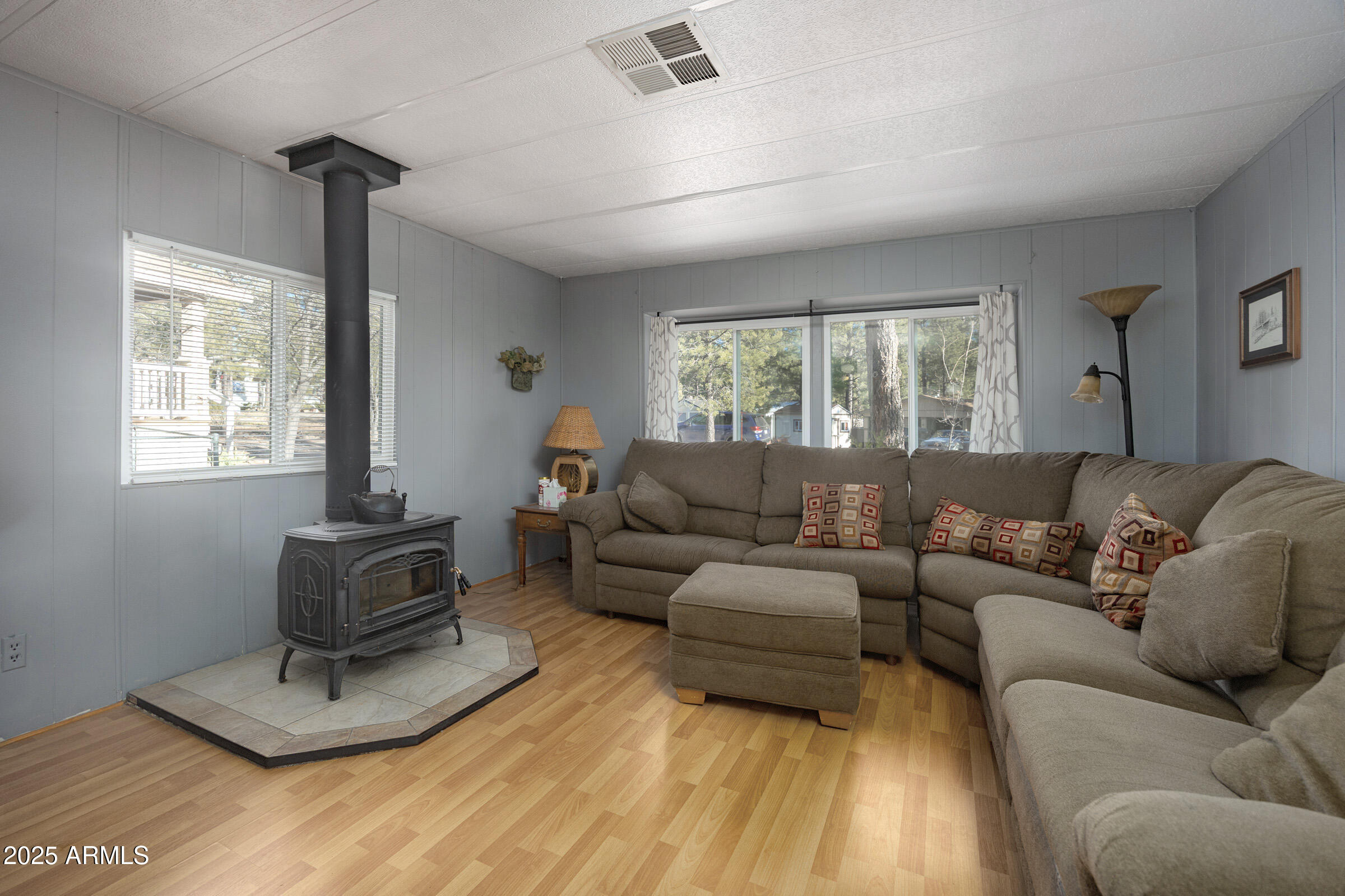 Charming Munds Park cabin surrounded by tall pines and just minutes from Pinewood Country Club. This move-in-ready home sits on an oversized 9400sq ft lot (Almost DOUBLE the standard lot size in Munds) and features a large covered front porch with gate, expansive storage (2 storage sheds & a workshop), an open living area with vaulted ceilings, a cozy wood stove, and great natural light. The kitchen offers generous counter space and easy flow for entertaining. Spacious bedrooms and well-kept bathrooms provide comfortable, practical mountain living. Enjoy outdoor dining and relaxing on the large deck overlooking the wooded lot. Plenty of parking for guests, ATVs, and outdoor gear. Close to hiking, off-road trails, and Coconino National Forest access. Short term rentals are allowed.