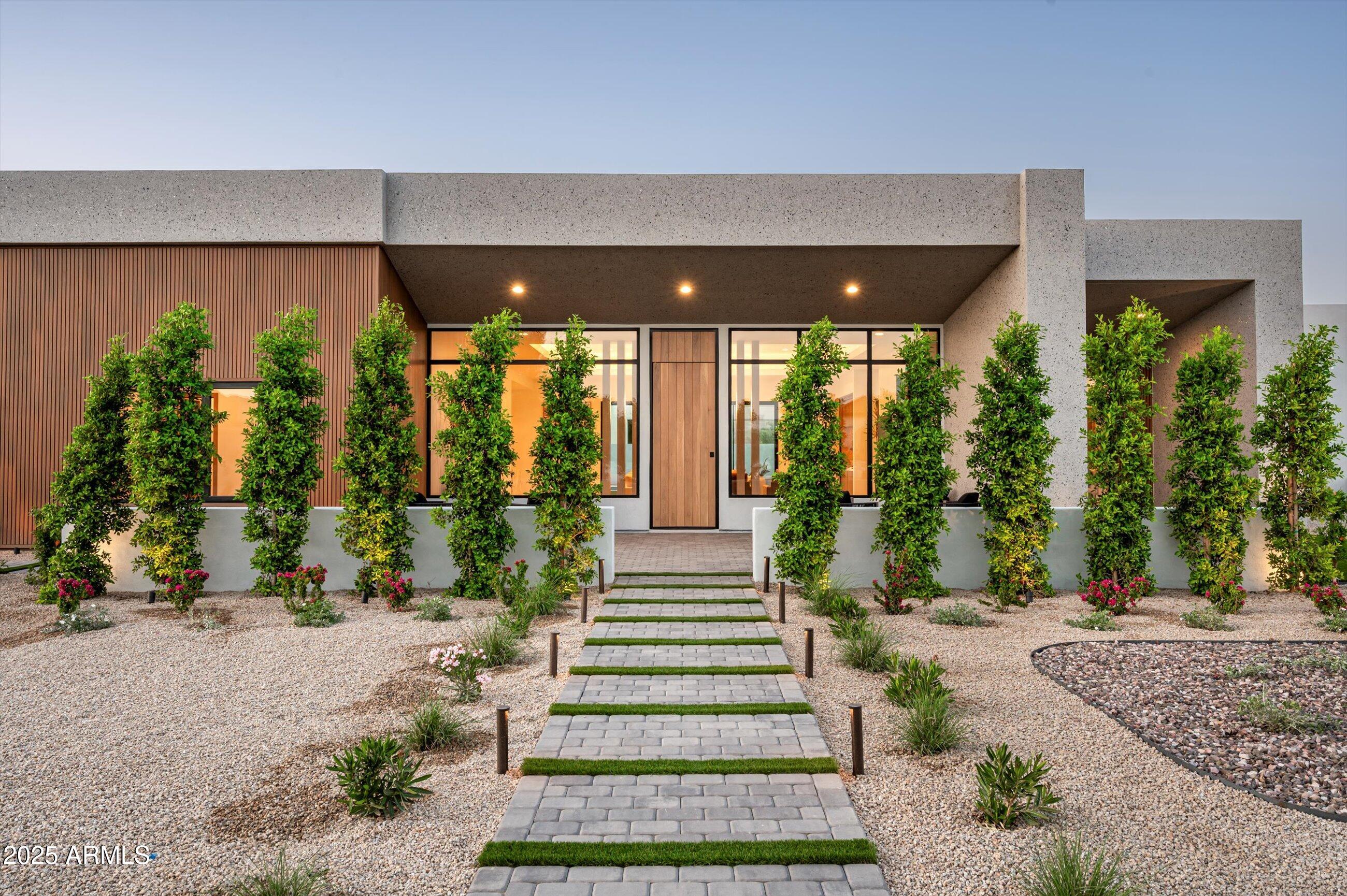 Brand-new construction in a prime Paradise Valley location, this home offers the perfect blend of architectural elegance, comfort, and thoughtful design. Set on a spacious lot, the residence features a unique elongated floorplan that creates two separate wings — one designed for privacy, the other ideal for guests and family living. The heart of the home is an open-concept great room that flows effortlessly into the kitchen and out to a large covered patio overlooking the pool, fire pit, outdoor BBQ, and expansive backyard — with ample room to add a garden, sport court, or casita. Every detail has been curated by the in-house team of architects, designers, and builders at UR Development, known for their commitment to quality and innovation.