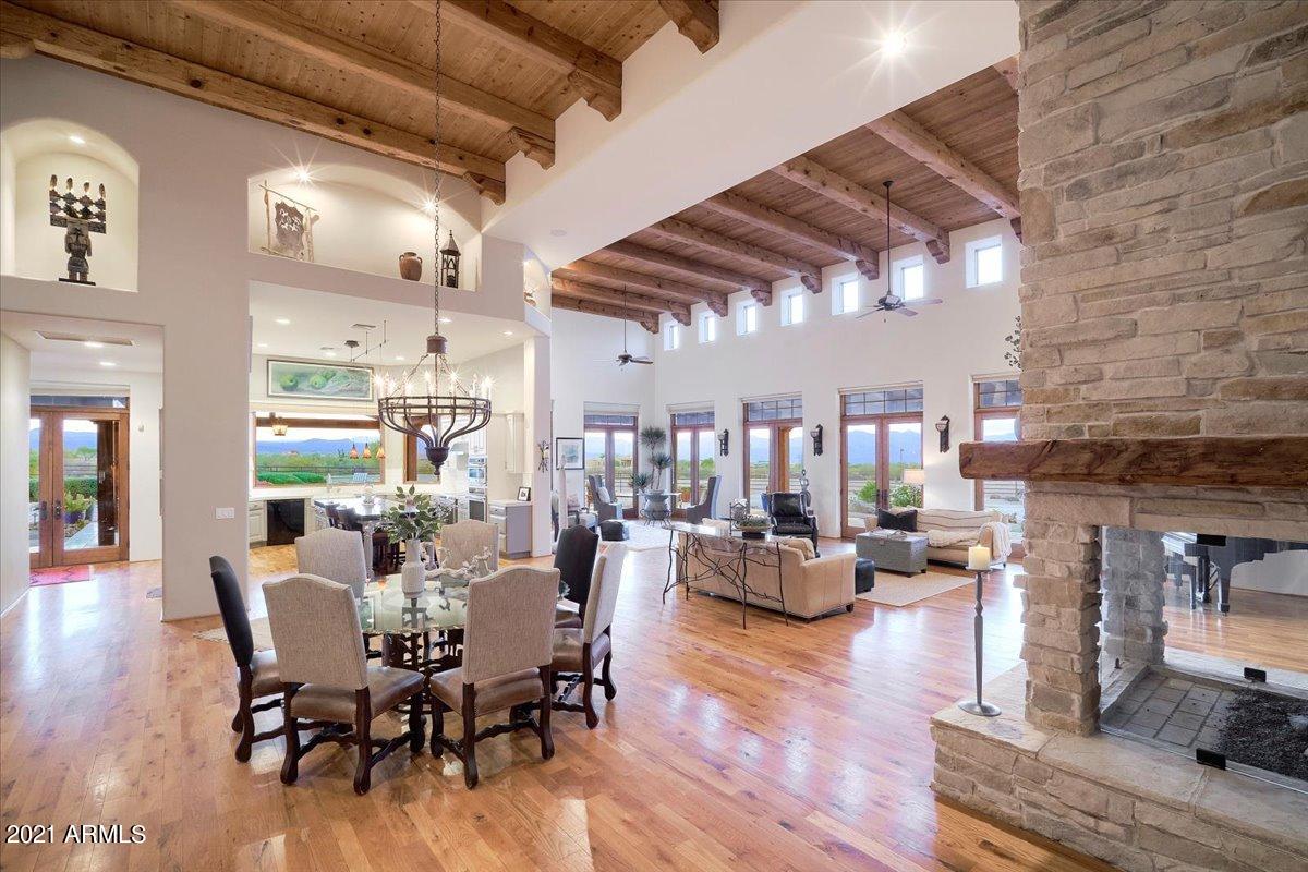 This home is also listed with an additional 5 acres for $3,950,000 under MLS number 6254212.  This luxurious private estate has had only one owner who has meticulously cared for and maintained the property with a recently added new roof, AC units, appliances and an updated guest house.  The open floor plan of the main house offers 5 bedrooms and 5 baths with panoramic mountain views from every room. The décor is tastefully appointed with hand hewn beams supporting 20 ft pine ceilings.  Upstairs is exclusive to the private 2nd Master Suite with all remaining bedrooms and living space on the 1st floor. The Casita and Guest house provides 2 separate guest quarters each with full kitchens and laundry.  The home is well constructed with all external walls containing foam insulation, all outdoor exposed wood beams are Cedar and Pella Doors and Windows.  The 500-gallon buried propane tank fuels 4 fireplaces as well as the grill and pool heater and the private well is 700ft deep with strong flow.   The property has a barn with 6 stalls and 6 connected runs as well as both a tack and feed room. The lighted arena is approximately 150 x 300 ft.  All furniture and artwork can be available as a turnkey.  This equestrian's dream is a must see!!!