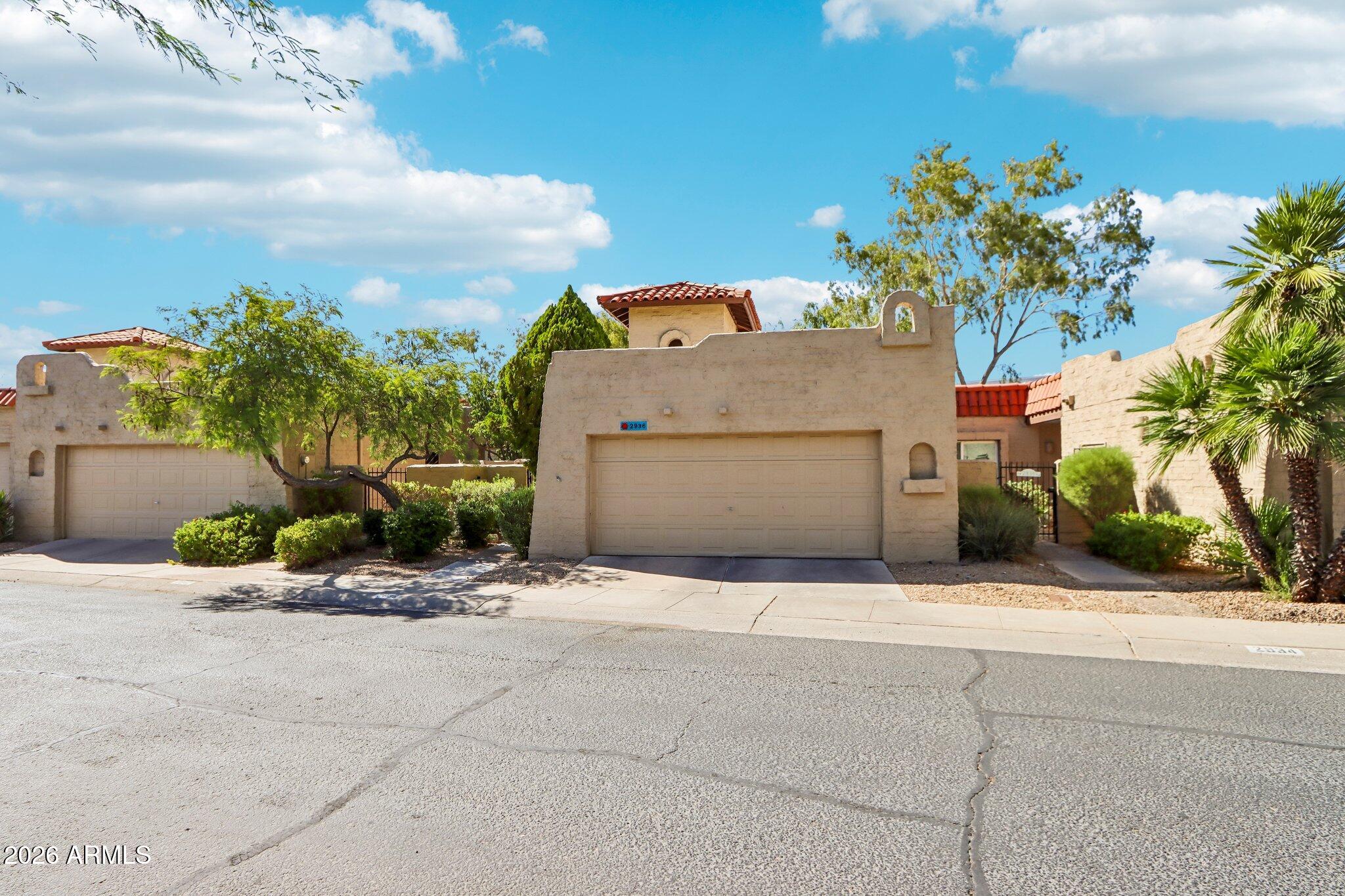 Charming Spanish Mission-style townhome in Missions Square! A dramatic covered two-story entrance welcomes you into this single-story home dripping with character. Step inside to a vaulted family room with a cozy fireplace and abundant indirect light. The kitchen offers hard-surface counters and a charming eat-in space connecting to the 2-car garage. The spacious master suite boasts an updated en suite with tasteful finishes, plus its own private patio retreat. Two additional bedrooms share a recently updated hall bath. Out back, enjoy a covered patio, fully fenced yard, and green space. Bonus: buyers may assume the seller's FHA loan at a 3% rate, subject to buyer qualification and lender approval.