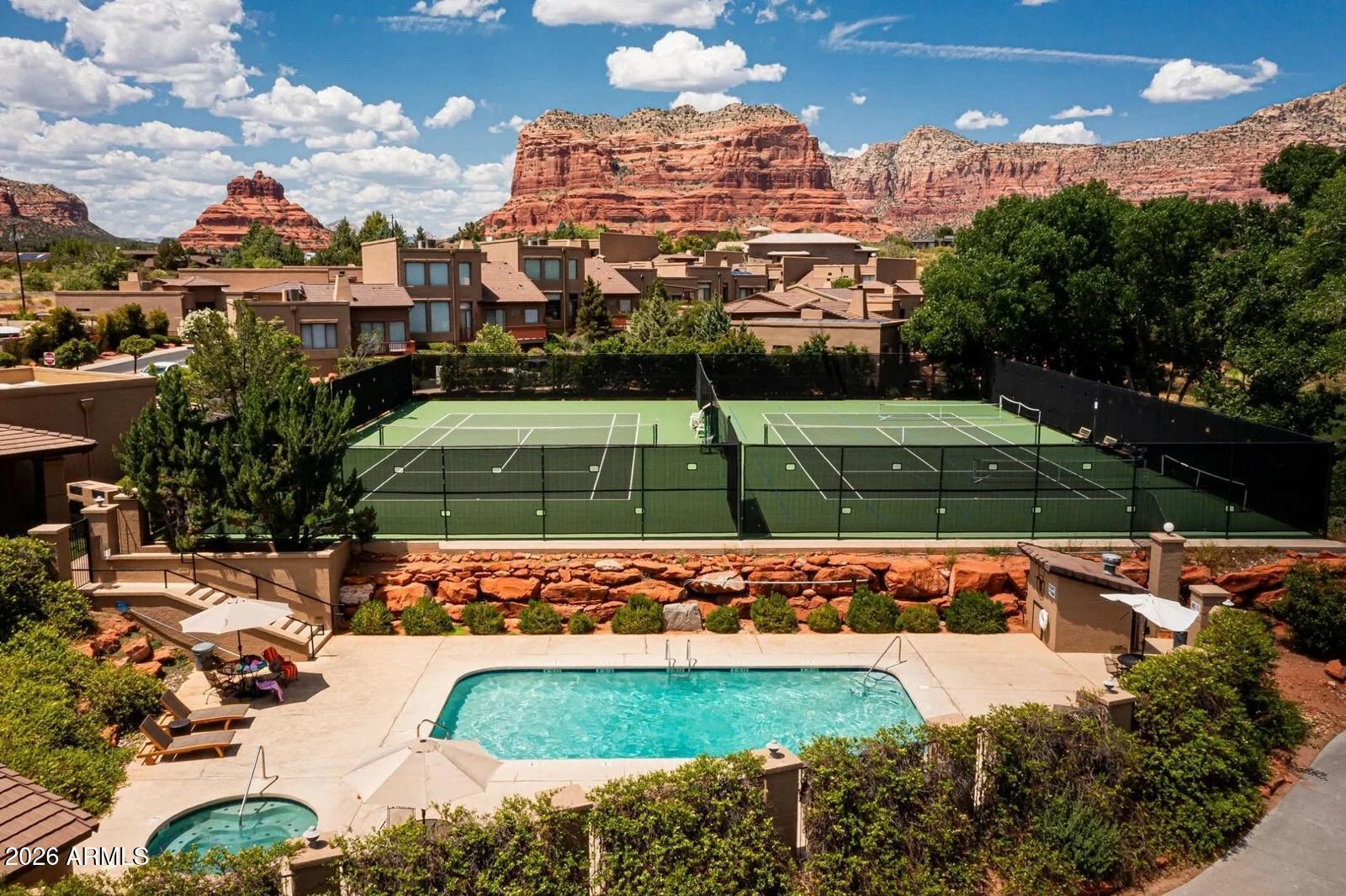 Experience Sedona's charm in this Cozy 2BR/2.5BA ''Casita'' in the gated Canyon Mesa Country Club. Bathed in natural light by 7 skylights, the open layout features 2 wood-burning fireplace and modern kitchen. A successful turnkey Airbnb with future reservations to convey, this gem includes a private back patio with a grill and lots of extra storage. Uniquely, the primary bedroom offers an en suite master bathroom, a 2nd fireplace and a private balcony for starlit nights. Enjoy a lifestyle paradise: unlimited golf on the 9-hole course, pool, spa, and pickleball. Nestled in the quiet Village of Oak Creek near Bell Rock and hiking trails; it's an ideal investment or serene retreat with spectacular red rock views. This pristine sanctuary offers the perfect blend of luxury and tranquility. 26 Copper Springs Dr, Unit 13  Expanded Public Remarks
A Light-Filled Sanctuary in the Heart of Sedona's Paradise
Discover the perfect blend of Southwestern charm and resort-style luxury in this exquisitely maintained 2-bedroom, 2.5-bathroom "casita" located within the prestigious, gated Canyon Mesa Country Club. As you step inside, you are immediately greeted by an abundance of natural light streaming through seven strategically placed skylights, illuminating the open-concept floor plan. The heart of the home is a spacious living area anchored by a classic wood-burning fireplace, perfect for cozy Sedona winters. The modern kitchen, featuring a breakfast bar, flows seamlessly into a comfortable dining and living area.  Enjoy a private covered patio, complete with grill and lush surroundings, the patio offers a tranquil space for alfresco dining or morning coffee in the crisp mountain air.
Unrivaled Luxury and Intentional Design
The upper level of this home is designed for ultimate privacy and comfort, featuring two expansive primary suites. The primary bedroom is a true retreat with its own en suite bathroom, uniquely offering a second fireplace for an intimate atmosphere and a private balcony that serves as your personal gateway to Sedona's world-famous starlit nights. As a Dark Sky City Sedona offers a celestial display that is second to none; from this balcony, the absence of city light allows the cosmos to take center stage. Practicality meets luxury with ample extra storage space throughout the home, making it an ideal choice for a primary residence, a "lock-and-leave" second home, or a high-performing investment property. Currently operating as a successful turnkey Airbnb with future reservations to convey, this home offers a rare, immediate revenue stream for the savvy buyer.
Lifestyle and Community in the Village of Oak Creek
Life at Canyon Mesa Country Club is akin to a permanent vacation. This quiet, picturesque community is a haven for active lifestyles, offering an executive 9-hole golf course with unlimited play for owners, a seasonal pool, year-round spa, and newly surfaced pickleball and tennis courts. Beyond the gates, the best of the Village of Oak Creek is at your doorstep. You are minutes away from the iconic red rocks of Bell Rock and Courthouse Butte, providing world-class hiking and biking trails. Whether you are seeking a serene retreat to recharge or a vibrant community to engage with, this pristine sanctuary offers a lifestyle of unparalleled peace and beauty. Experience the magic of Sedona in a home that truly offers the best of both worlds