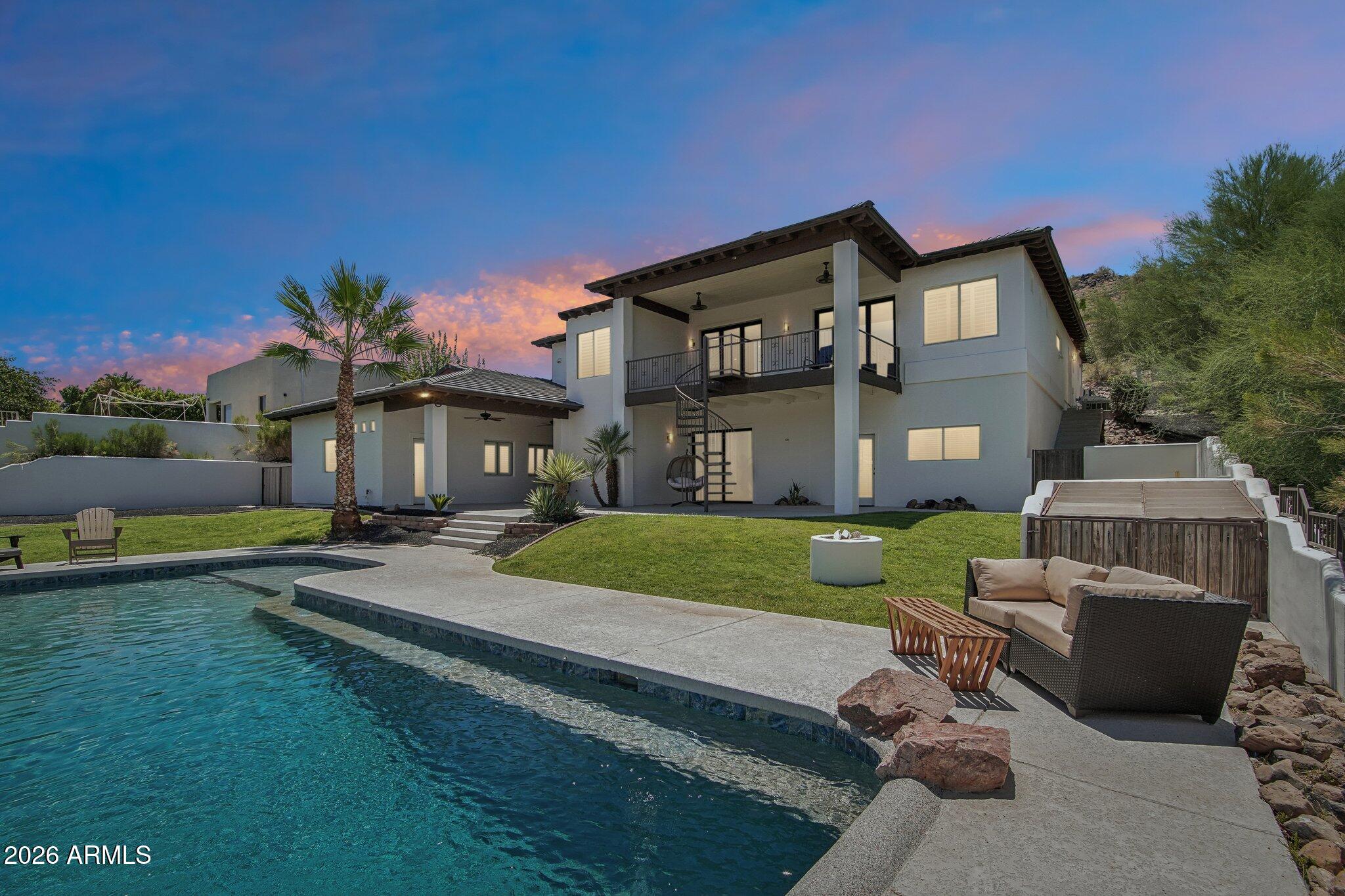 Custom hillside home offering breathtaking views! This impressive residence features 6 bedrooms, 5.5 baths & approximately 4,485 sq ft of space on a .33-acre lot. The grand foyer opens to a light-filled floor plan w soaring ceilings, Travertine flooring & designer details throughout including Onyx walls & custom iron doors. The gourmet kitchen boasts granite countertops, high-end appliances, multiple ovens, pot filler, expresso machine & breakfast bar. The luxurious primary suite includes a covered balcony w stunning views & a spa-like bath. A finished walk-out basement offers a theatre & storage space and even an attached casita w kitchen and a separate entrance. Resort-style backyard features a newly finished pool with waterfall and nestled for views w lush grass for play & a firepit.