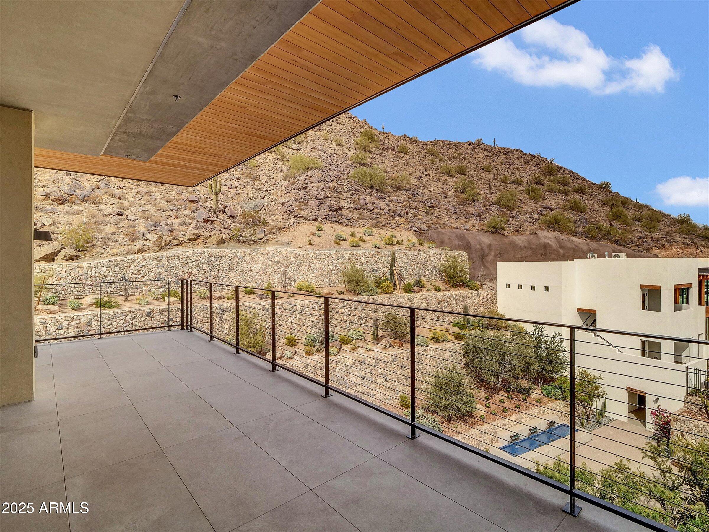 This is a rare opportunity to own the condo of your dreams. This is a one of a kind! Penthouse condo is nestled up against Camelback Mountain, with amazing mountain views from every window and balcony. The city views are mesmerizing along with the tranquil pool and horizon views for miles. This brand new 3 bedroom 3.5 bath condo has a bonus room w/fireplace and back kitchen. Has been upgraded with a Bulthaup custom kitchen, 2 SubZero fridges, Wolf induction cooktop, oven, and microwave. 200 bottle SubZero wine fridge, 2 dishwashers, and front loading washer and dryer. Upgraded Creston lighting, shades, thermostat and more. Don't forget the endless amenities. Concierge service, mountainside clubhouse, pool, hot tub, state of art work out facilities and steps away from the famous Phoenician