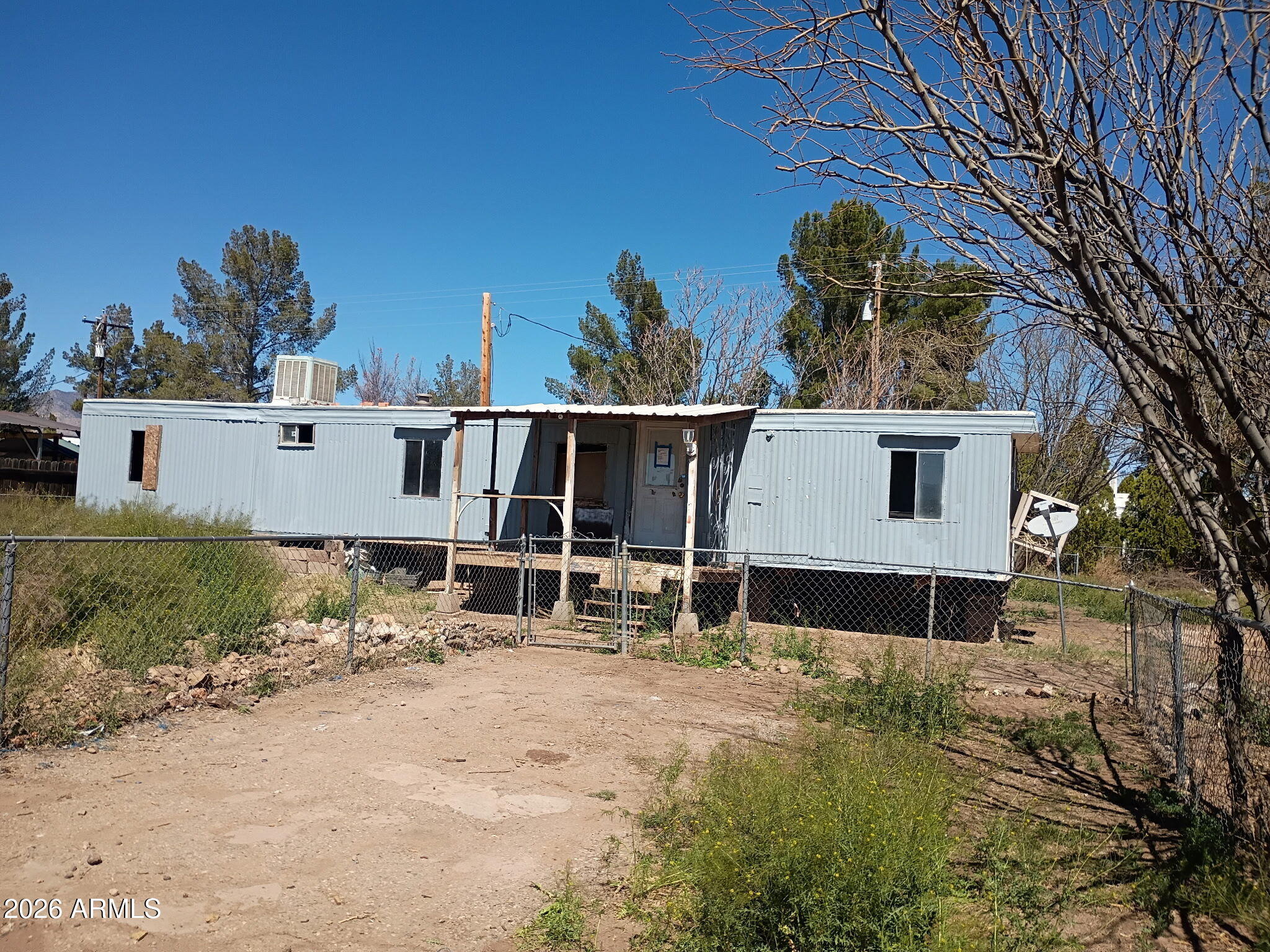 Two unaffixed single wide mobile homes put together - total 1272 sq ft - 4 bedroom, 2 bath in Whetstone section of Huachuca City - large lot - mostly fenced - needs some work to make it beautiful.