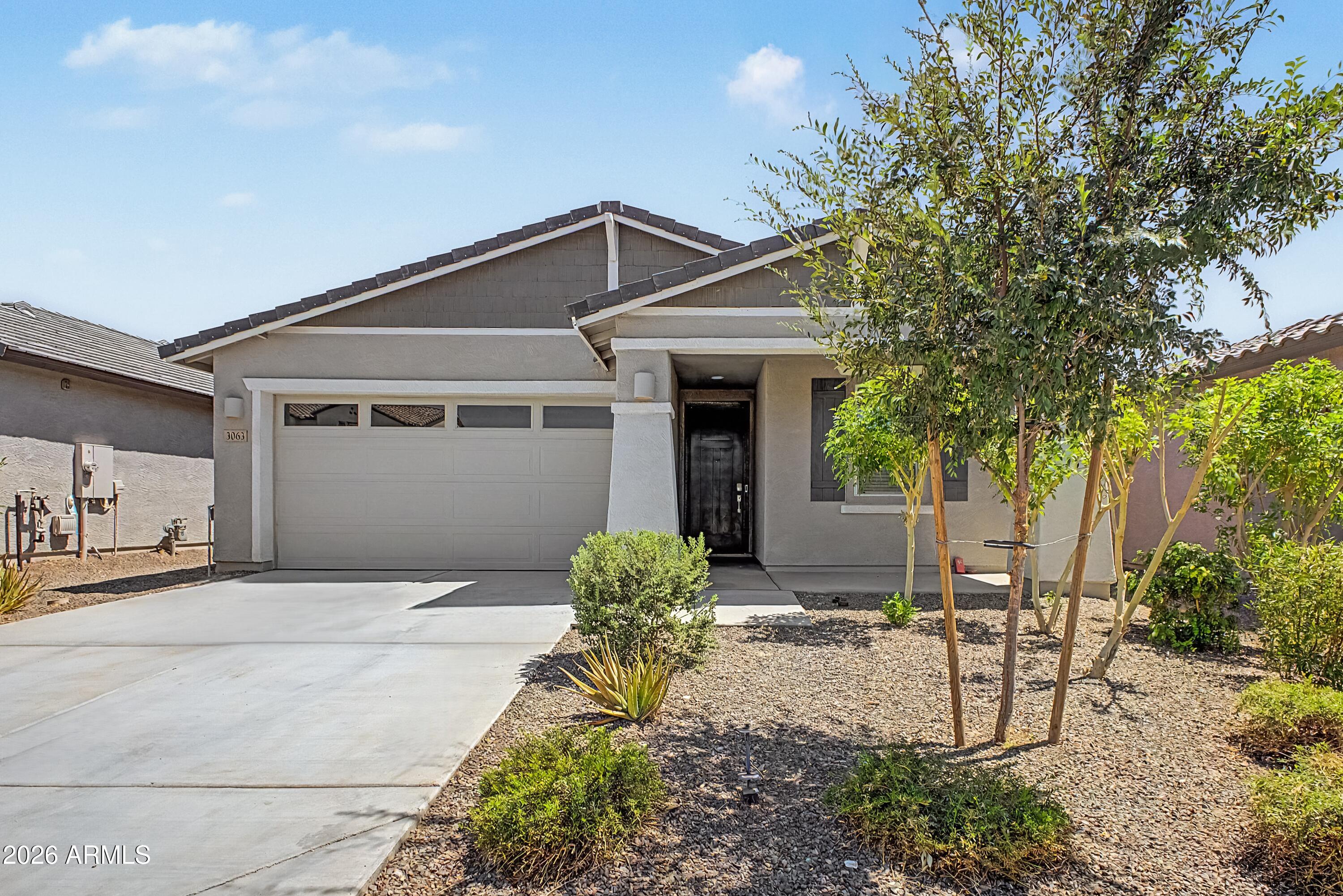 Why wait for a new build? This stunning, 5 Bedroom, 3 Bath, 2023 single-story home in the premier Wales Ranch community is just what you have been waiting for. Boasting 1,961 sq ft, this clever layout maximizes every inch at the heart of the home, an open-concept great room that connects seamlessly to a bright, modern kitchen, making entertaining a breeze, offering a standout feature - a dedicated guest wing: a spacious 5th bedroom with its own adjoining full bath, perfect for multi-generational living or out-of-town visitors. Contemporary finishes, crisp modern lines, and abundant natural light flow through the main living areas. This beautifully maintained, single-level home offers everything you're looking for today, even conveniently located to local amenities, and San Tan Regional Pk.
