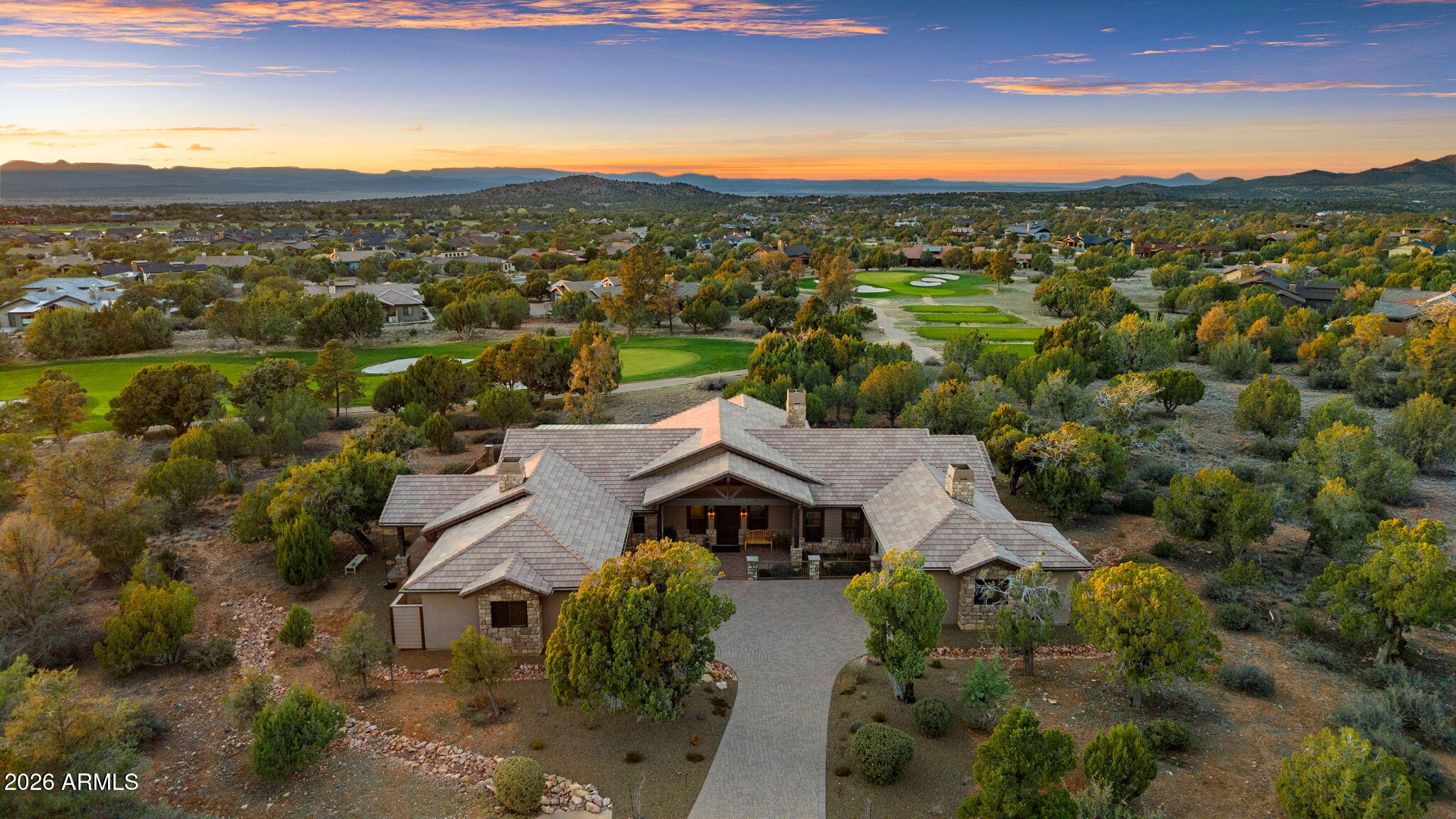 Positioned on the 6th green of Talking Rock Golf Course and bordered by HOA common space for enhanced privacy, this exceptional residence offers a refined blend of luxury, serenity, and panoramic golf course views. Thoughtfully designed and impeccably maintained, the home captures natural light throughout its expansive open-concept layout, anchored by a dramatic floor-to-ceiling stone fireplace and elevated designer finishes. The luxurious primary suite is a private retreat, featuring dual walk-in closets and a spa-inspired ambiance. At the heart of the home, the chef's kitchen is both sophisticated and functional, appointed with slab granite countertops, Blanco sinks, and a full suite of premium Wolf and Sub-Zero appliances, including a 36'' refrigerator and freezer, gas cooktop, double ovens, built-in coffee system, warming drawer, and an expansive butler's pantry designed for seamless entertaining. The dining space is enhanced by a custom built-in bar with wine refrigeration, creating an ideal setting for intimate gatherings. Outdoor living is equally impressive, with a covered patio, built-in BBQ, and a fully fenced backyard--perfectly positioned to capture the surrounding beauty and tranquility. Completing the property is an oversized three-car garage with deep bays, epoxy-finished floors, and extensive custom built-ins, offering both functionality and sophistication. A rare opportunity to experience elevated golf course living in one of Prescott's most sought-after communities. Talking Rock is an exclusive private golf community offering members and their guests an unmatched blend of hospitality, comfort, and western elegance. Amenities include an award-winning Jay Morrish-designed golf course, a state-of-the-art Fitness Barn, the Ranch House Restaurant and Bar, Coop's Coffee House, a Members Lounge, racquet sport courts, a dog park, a community garden, and over 14 miles of scenic hiking and biking trails. Enjoy a mild four-season climate that allows for year-round golf and outdoor recreation in a truly exceptional setting.