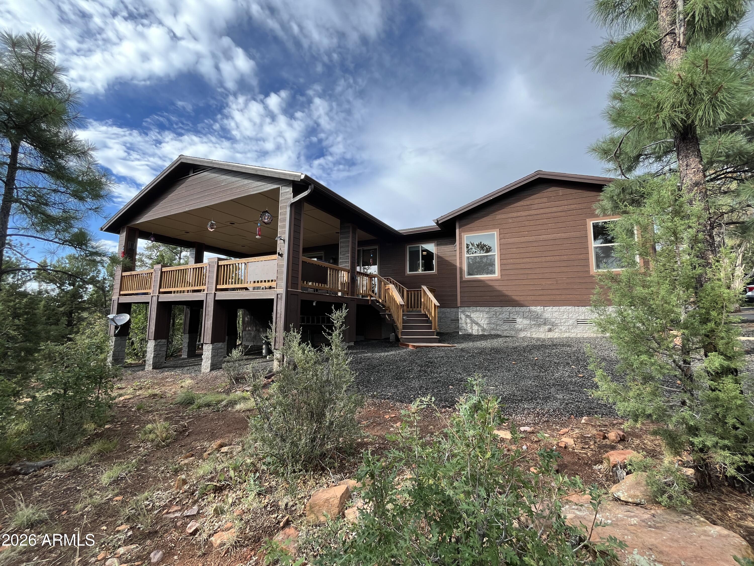 If you are looking for the perfect mountain home, this is it. An incredible single-story immaculate custom home with amazing views from the 600 sq ft deck! A separate workshop and apartment above it with an RV hookup just outside. The main house boasts marble countertops, black walnut cabinets in the kitchen, power window shades in the LR, a Ring System, wired AV system, drainage system, 3 car garage. Guest room has its own deck. You must see this beautiful Sierra Pines gem!