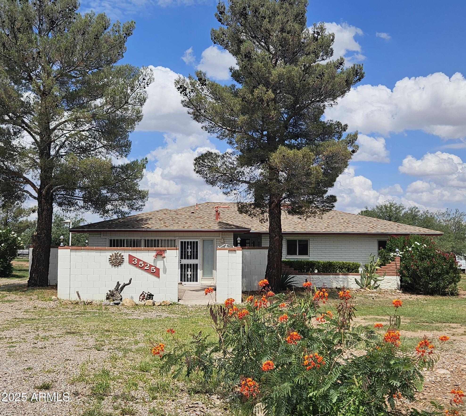 This home offers a lot of value for the money! 3 bedroom, 2 bath, living room with gas log fireplace, family room with gas stove. Entire house is ceramic tile or laminate floor except the family room, which has carpet. Electric Heat Pump. Brand new built in Microwave. Block wall around back yard and block courtyard in the front! Detached 2 + car garage/workshop is approximately 850 sq. ft. and could be converted into a 3 car. Large, tall metal awning for covered storage or maybe an RV. Desirable location and close to town!