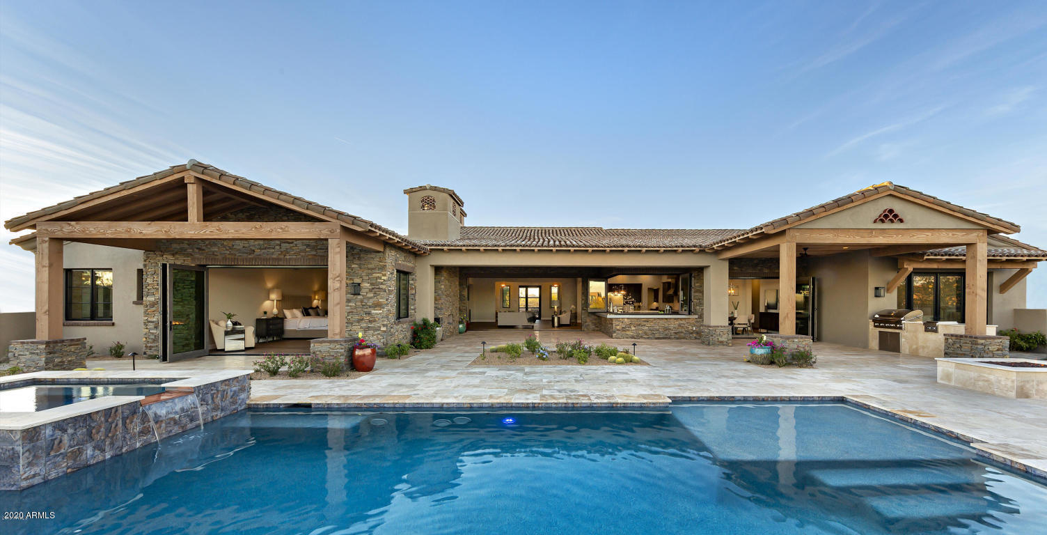 For the finest Lineage custom built home on a spectacular Mirabel golf course lot look no further. The open transitional floorplan showcases walls of retractable doors and expansive patios for outdoor living at its finest. This 6482 s/f home features imported weathered beams, an oversized 4 car garage and motor court, luxury kitchen with oversized island and Wolf/Sub-Zero appliances. The spacious great room features a large stacked stone fireplace and 20' retractable window wall to the patio. The large master suite features a coffee bar, refrigerator, stacked stone fireplace and huge closet with washer/dryer. The 2 room casita has a kitchenette, living room and large bedroom and bath. The cantina bar opens to the patio which also features an outdoor kitchen, pool/spa, and fireplace. This Jon Poetzl designed home was built by Lineage homes one of the top custom home builders in the valley. This home overlooks a glistening fairway lake on the 10th hole of the award winning Mirabel Golf Course. The home is surrounded by breathtaking views of sunsets, city lights and majestic vistas of Pinnacle Peak. This one of a kind custom home is under construction and due to be completed this summer. The floor plan, standard features list, and more information can be found under the document tab of the listing.