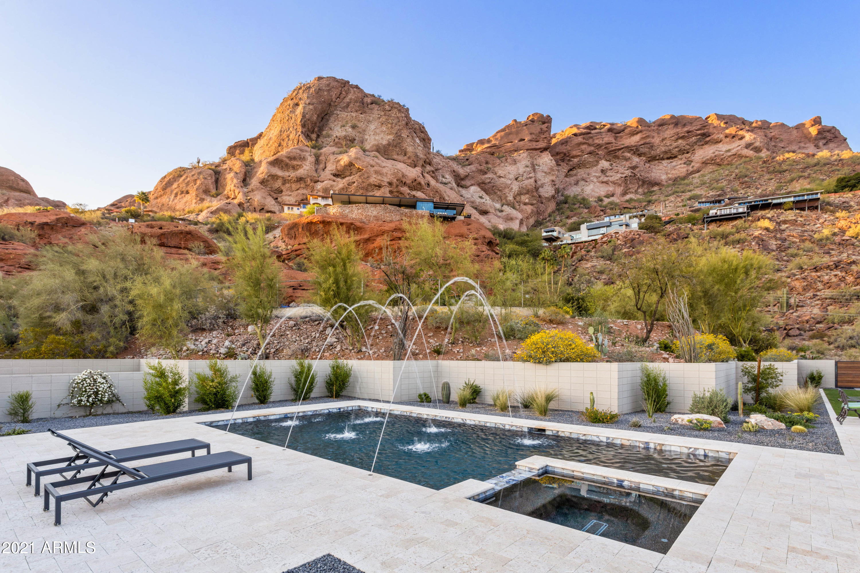 Just fell out of escrow...Your Gain! Jaw dropping Camelback Mountain views with sleek mid century inspired architecture. Completely rebuilt in 2018 with no cost spared. This open concept home features 4 bedrooms, 4 bathrooms, 3+ car garage and incredible indoor/outdoor entertaining space. Wood floors, automatic shades, gas fireplace, surround sound and high end finishes. Stunning kitchen with clean lines, large island, Wolf range, Sub-Zero fridge/freezer, Asko dishwasher, walk-in pantry & wine fridge. Spacious master bedroom with two beautiful walk-in closets and designer bathroom featuring marble flooring, dual vanities, private water closet, soaking tub & a generously sized shower. Panoramic city & mountain views with unobstructed lines of sight to Camelback, Papago & South Mountain. The exquisite backyard which boasts a heater pool, jacuzzi, water features, turf, meticulous landscaping and covered bbq.  The Marbella Shellstone pavers are ideal for AZ, regardless of outside temperature, the pavers do not get hot.  This home will not last long, so schedule your private showing today.