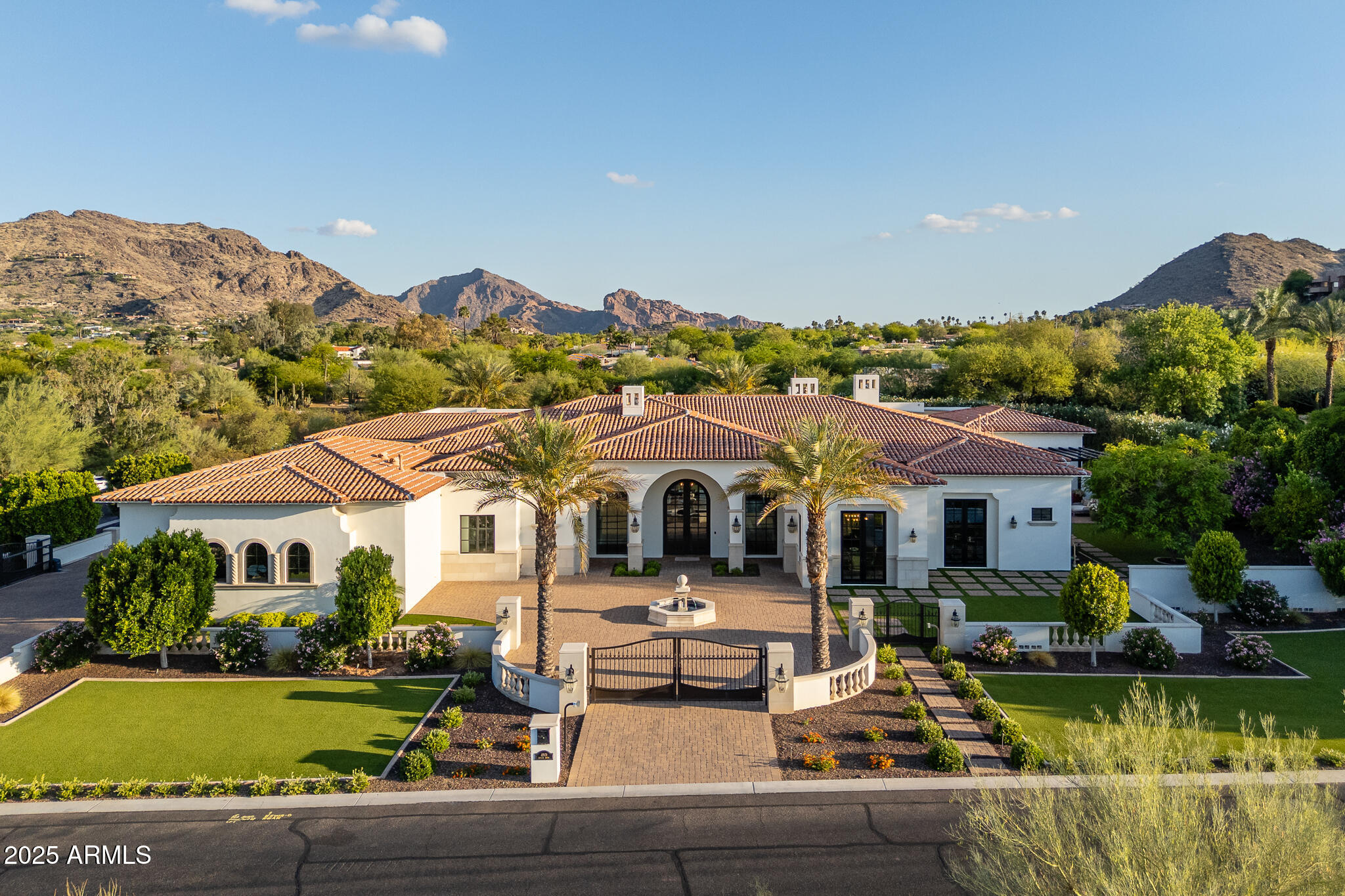 Privately gated and perfectly tucked in the prestigious shadows of Mummy Mountain with commanding views of Camelback, this Santa Barbara-inspired estate is a breathtaking blend of timeless architecture and modern sophistication. Situated on just under 1.4 acres of prime Paradise Valley land, this exquisite custom home offers over 8,600 square feet of refined living space with 6 en-suite bedrooms, 7.5 bathrooms, and an attached casita with its own single-car garage and entrance. Soaring vaulted ceilings and a 34-foot pocket slider create a seamless transition between indoor elegance and outdoor grandeur. The gourmet kitchen is a true showpiece, featuring dual oversized islands, Wolf appliances, marble countertops, and butler's pantry designed to impress the most discerning chef The grand primary suite is a private sanctuary, showcasing a dramatic 12' x 12' corner pocket slider, his and her oversized custom closets, its own dedicated laundry room the most important thing for a happy marriage... separate water closets. This primary suite is designed for ultimate convenience and luxury.

Step outside into what can only be described as a five star resort-caliber oasis. The meticulously designed grounds boast two stunning pools, a swim up bar, a spa-quality jacuzzi, a custom detached pool house, two outdoor kitchens, a sunken pavilion ideal for entertaining, a tranquil outdoor atrium, and over 3,000 square feet of covered patio spaceall surrounded by lush, mature landscaping for total privacy.

A 5-car climate-controlled garage rounds out this extraordinary estate. This is not just a homeit is an unmatched lifestyle offering in one of the most exclusive enclaves in Paradise Valley.

The attention to detail through out this estate is truly remarkable , Schedule your private tour today!