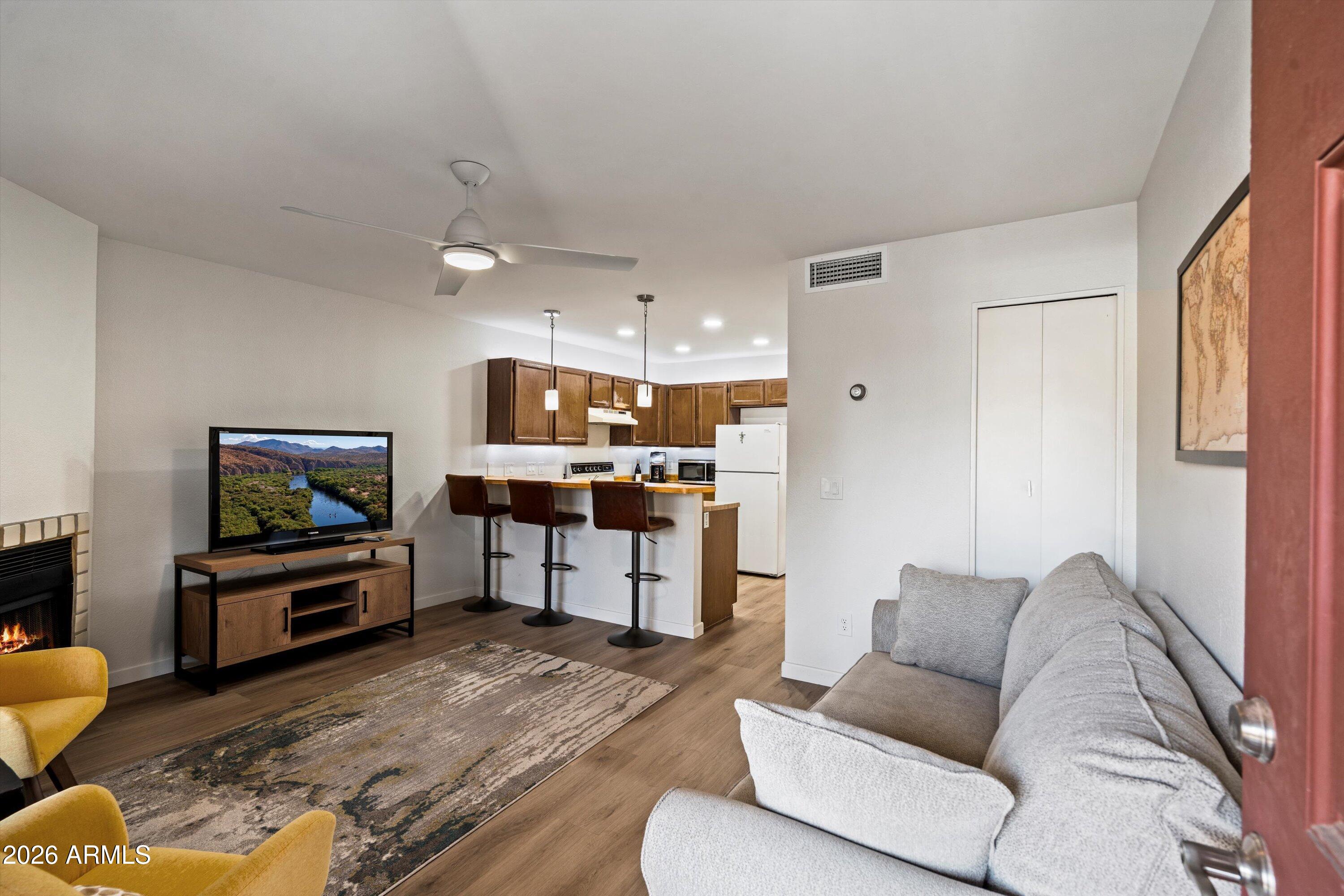 Experience the ideal blend of Scottsdale prestige and Phoenix affordability in this charming 1-bedroom, 1-bath condo located in the highly desirable 85254 zip code. This ground-level unit features a cozy wood-burning fireplace with brand-new vinyl flooring, creating a warm and inviting atmosphere. Enjoy your own private backyard, perfect for relaxation. Located just minutes from Desert Ridge, Kierland Commons, and Scottsdale Quarter, you'll have access to premier shopping and an array of exceptional dining options. Don't miss your chance to claim this cozy retreat as YOUR home!