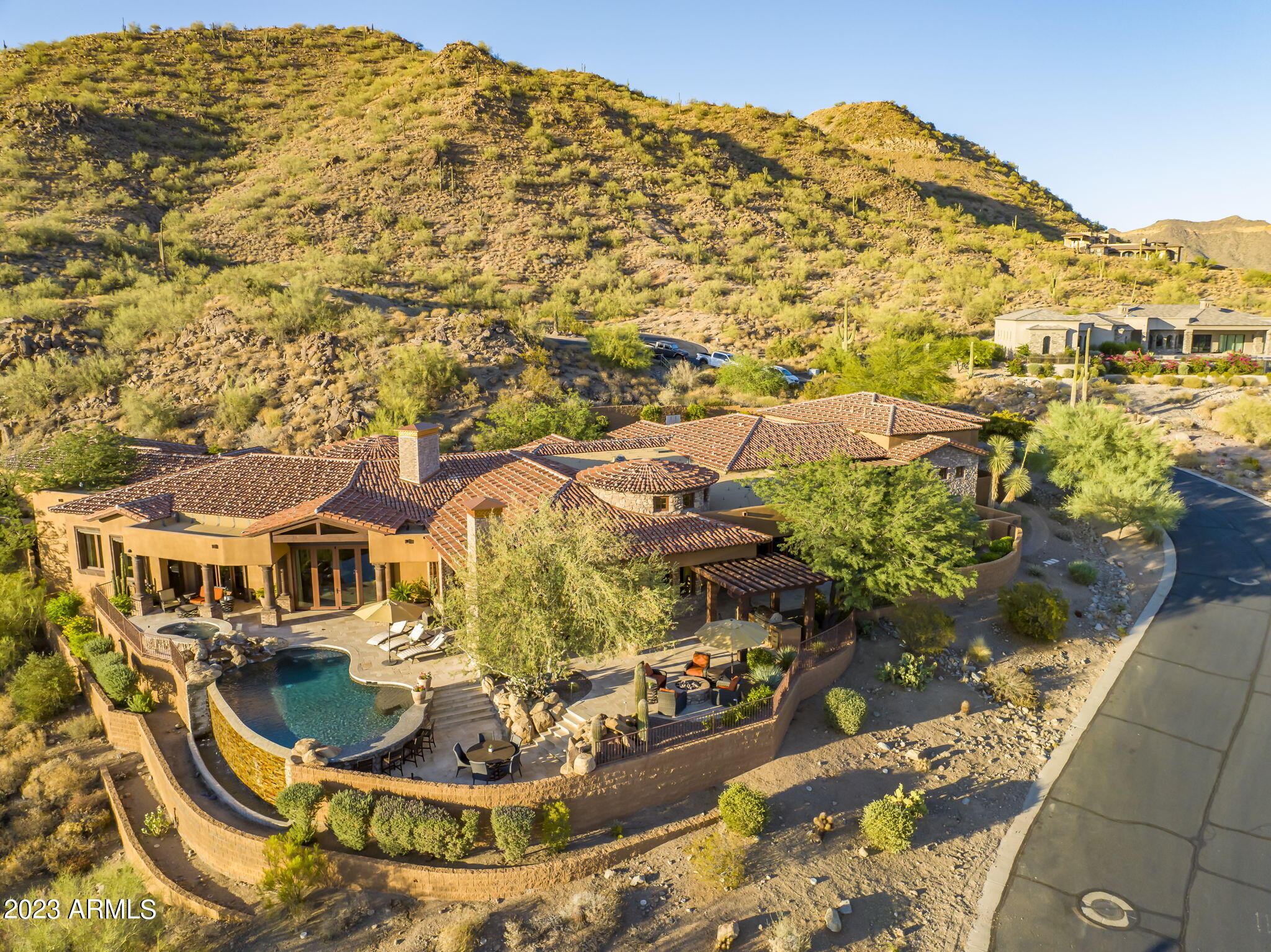 Views, views, views! Discover this 2-acre mountainside gem, 7,500+sf home w/guest house & 7-car garage blending luxury & functionality. Property features meticulous architectural design, cutting-edge technology, top-tier materials & the stunning backdrop of city & mountain panoramas in the exclusive master-planned community of Las Sendas. 5+bedrooms w/attached baths for the utmost privacy, convenience & comfort. The owner's suite showcases awe-inspiring views, spacious bedroom w/ coffered ceiling and spa-like bathroom featuring 2 marble vanities, 2 toilets, 2 closets, steam shower, soaking tub & laundry area. The owners' wing includes a generous office w/walk-in storage & an exterior visitor entrance. Enjoy your fully-equipped gym opening to the pool & spa too. Gourmet kitchen awaits you The gourmet kitchen awaits you w/ Viking appliances, breakfast bar, 2 sinks, 3 ovens, 8 stove-top burners, 2 dishwashers, and ample storage space, complemented by a large informal dining area. The kitchen opens to the main family room, complete w/ gas fireplace. For entertainment a media/theatre room & full wet bar is connected to the kitchen.
Welcome guests from the foyer to the formal living room, featuring retracting glass doors that open to your private outdoor oasis. The dining room is ideal for larger gatherings & intimate conversations, with a wine cellar located nearby. 
Discover paradise in your backyard, with kitchen, a negative-edge salt-water pool/spa, and 2 fire features all landscaped to showcase the captivating views.
Adjacent to the main house, an independent guest house beckons, offering family room, kitchen, bedroom, bath, laundry hook-ups, & private patio with breathtaking views. The property also includes a remarkable 7-car air-conditioned garage & RV access plus, a workshop area, ample storage space, and convenient ½ bath.
The home backs to the serene Tonto National Forest.  Las Sendas residents enjoy community amenities-swimming pools tennis & pickleball courts fitness & event centers, walking & bicycle trails, and options to play the 18-hole golf course.
This Las Sendas estate is located within the highly regarded Mesa Unified School District; conveniently situated just 25 min to Phoenix Sky Harbor Airport. Experience a life of luxury, comfort, and natural beauty in this extraordinary mountainside retreat.