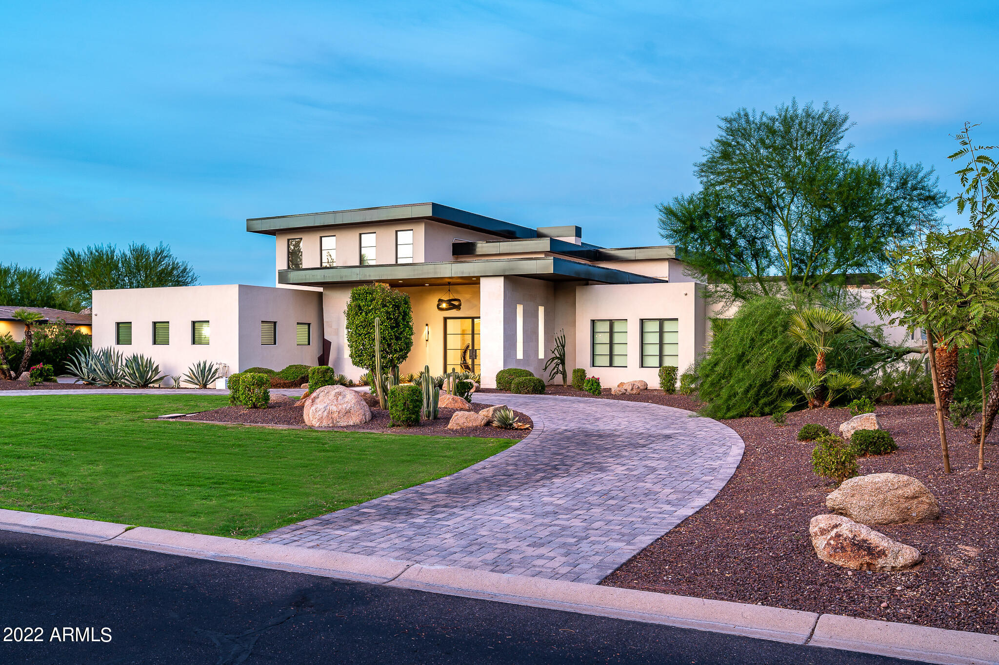 Timeless luxury in an absolutely stunning location of Paradise Valley! This exceptional and functional modern masterpiece built in 2017 proves breathtaking the moment you step inside. Fully Furnished! Intimate yet spacious home at 8,522 total sq. ft built on over an acre lot. 6 total bedrooms, 9 bathrooms and 2 offices with a newly designed state of the art home theater. Dramatic soaring ceilings with an abundance of natural light. This desirable open floor plan embraces clean lines throughout with no expense spared. Low-e insulating Argon Pella windows, envious design elements & lavish finishes. This includes oversized honed Austin limestone columns & DaVinci safe touch glass that can be seen through the focal point fireplace with a split faced limestone finish. Primary bed/bath is a true spa like oasis with walls of glass, two private toilet rooms and two expansive closets. Ultra modern kitchen with Wolf Sub-Zero, Askura Appliances, Bravura hardwood, Elwood frameless cabinets and attached butler's pantry. Walk out the living room through your disappearing glass door and into your stylish backyard sanctuary. Enjoy the outdoor kitchen overlooking the resort style heated pool and spa. Head over to your 384 sq. ft. pool house which includes your workout room and a full bathroom, just a few feet from your fully lit tennis court. Practice your golf game with a putting green and driving net on the side yard with a retractable awning for additional shade. 4 car garage attached to the main home and a 1 car garage attached to the 1,018 sq. ft. guest house, which also includes a full kitchen and laundry. Multiple chargers available for your Electric Vehicles in the garages. Smart technology including but not limited to: Smart Thermostats, Automatic Lights/Toilets/Blinds, Pool Controlled on Smart Phone, etc. Embrace luxury and wealth with simple, but elegant shapes and intentional privacy. Don't miss this unique opportunity to own an impressive gem in Paradise Valley!