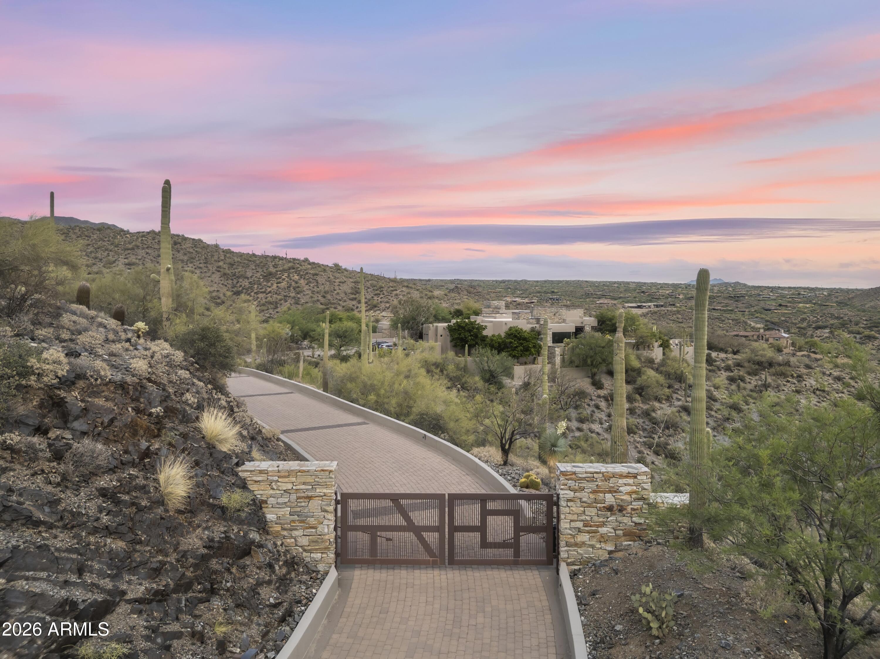 Sprawling 24.5-acre Guard Gated mountaintop estate within Carefree Ranch Homesteads occupies a rare south-facing peninsula-like ridge where architecture, privacy, and desert grandeur converge. A private gate and descending drive lead to a large motor court, creating a dramatic sense of arrival. The residence is positioned to command uninterrupted panoramas of city lights, layered mountain silhouettes, and Arizona's spectacular sunrises and sunsets. Designed for those who value quality and seclusion, the home is a study in elevated desert living, including thoughtful indoor-outdoor connections, and top-tier amenities which enhance the natural drama of the site. Every detail, from the approach to the living spaces to the expansive view corridors, has been composed to celebrate scale... , serenity, and the art of living. Exceptional in its setting and rare in its offering, this estate delivers a level of privacy, presence, and visual impact seldom found at this price point. A true mountaintop sanctuary, inviting a lifestyle defined by quiet luxury architectural distinction, and sweeping views that feel entirely your own.