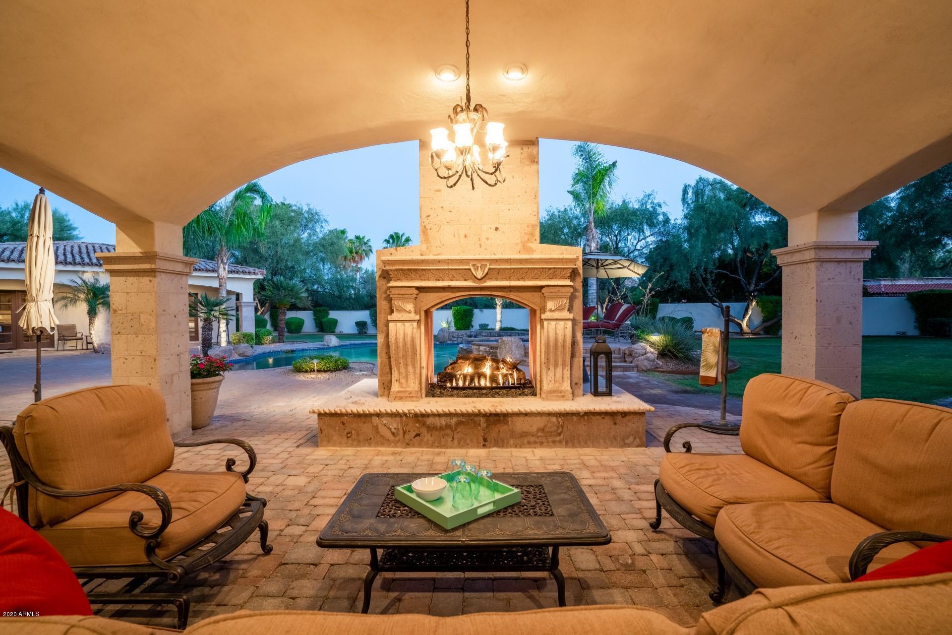 A true Masterpiece that was personally designed and constructed by famed builder, John Sebald, and his Santorini Custom Homes' team.  John saw that the home was optimally situated on this incredible acre+ of land in prestigious Camelback Country Club Estates. Luxury, privacy, tranquility, opulence and functionality, attention to detail, and of course only top of the line materials and finishes. As you arrive from the daily busy world, you are greeted by an impressive entry gate, through which you pass onto the beautifully designed paver driveway and enter a truly magical world. The driveway features a mature specimen Mesquite as the center focal point. As you walk through the luxurious private gated courtyard this leads to the impressive front entry of the home. So much more in Supplement! Don't miss the video!  Also, see docs tab for floorplan. 

Quick overview: Like NEW---a sparkling Santa Barbara w/tremendous curb appeal! N/S, culdesac, privately gated mountain view lot, in PV's sought after Camelback CC Estates. Magnificent details of 24-inch stone and hand distressed wood floors. Split master and spacious open floor plan for grand scale entertaining. Barrel vault/beamed and domed ceilings/wet bar/media room. Full detached guest house with 1 BR/1BA kitchen and laundry facilities. Gourmet kitchen w/Viking gas range/double SubZeros/slab granite countertops. Private master retreat with large wi-his/her closets, office and gym/flex room w/bath. Pool/spa/outdoor fireplaces/grassy play area/dog runs/pavers---6-car garage with private gate. Main Hse/6571SF, Guest/708 SF.
 
Like open concept? If so, this is the home for you. The kitchen is open to the large family room, and likewise the family room is open to the bar and billiards room. All of the main entertainment areas are open to each other, so whether its daily living or when you are entertaining, your family, or guests, will never feel separated from each other. The bar is perfect for all size gatherings large and small, even if it's just you by yourself.  It's an impressive bar, with an excellent seating area, lots of countertop and cabinet space, and a large wine cellar. There is also a formal living room that features triple french doors leading out to the rear patio, and the formal dining room can seat many. 

Resort like backyard, featuring a beautiful pool, spa, waterfall feature, dramatic pool lighting, all connected with an electronic control pad. There is an abundance of seating/lounging areas, both covered and uncovered so you, your family, and guests can enjoy! The are many grass areas in the backyard for the kids or pets to play. Beautiful landscaping surrounds you throughout the various yard areas.  There is an impressive size outdoor bbq island perfectly situated off the pool.  The main covered patio is located off the family room and it's very large and  it affords both daytime and nigh time full enjoyment of the pool and lush backyard views. A impressive stone gas double sided fireplace gives some separation from the covered patio to the pool and the flow and seating areas work well when entertaining. 

All bedrooms are generous sizes and each features a private on-suite bathroom and walk-in closet with custom closet organizers, the kids will love it! 

The kitchen has all of the bells and whistles you can imagine, very well designed. So much countertop space and cabinets, and a large center island. High-end cabinets, finishes, all with perfect design and layout. Top of the line appliances with a industrial size double sub zero refrigerators and a 6 burner double Viking gas oven that features a custom wood covered venting system.  
This kitchen is spacious and a definite focal point of daily living and perfect when many guests are over. Double french doors lead out to the main courtyard, and afford soothing morning views from the kitchen table. Two good size pantries also.    

Ever walk into a home with views from the front door looking thru to the backyard?  This home has that also.  In fact, when you tour this home stand at either end of the impressive halls, it's quite impressive, something you'd typically only see at homes double this price range. 

There are beautiful Travertine floors and high end wood flooring in nearly all rooms.  The Travertine was recently cleaned and polished.  

Want privacy? This home has a perfect split floor plan designed for everyone's privacy in mind. The master wing of the home is located on the West side of the home along with the office; and the guest bedrooms, movie room, laundry room, and garage access located on the East side of the home. 

The master suite is impressive in size, and has a focal point an impressive fireplace.  French doors lead to the rear backyard.  The master bathroom features separate areas of his and her sinks, a soaking tub, generous size shower, and enormous size his and her closets located at each end of the bathroom.  There is his toilet room and she has her own toilet room with a bidet. Designer closet organizes with an island. A separate door leads out to the West private courtyard, a perfect place to have your morning coffee and read the paper.  There is a beautiful fountain in the courtyard. 

The office is perfectly situated off the master and it also has a private entrance off the main courtyard should you have business clients over, there is no need for them to go thru the main entrance of the home should you so choose. 

There is also an exercise room located off the courtyard 20' from the office, don't miss it when you tour the home. 

The movie room has excellent seating arrangements and in this new covid world it's nice not to have to go out to the movies, and no need to as you have your own private movie room, complete with a popcorn machine.  In fact, why go out or have a hotel staycation?  This home has everything you need: resort like pool and backyard, movie room, billiards room, bar and wine cellar, various indoor and outdoor dining options, an exercise room, a beautiful office, and so much more! 

The entry courtyard is located off the main paver driveway, and it's a huge courtyard, with many seating areas.  The main seating area is located off the kitchen and has a beautiful outdoor fireplace.  A perfect spot to have morning coffee, lunch, dinner, or a drink.  There are so many various outdoor seating areas that you have to choose from. 

The home has a separate guest casita which has a good size kitchen that is open to the family room.  The master likewise is a good size with private french doors leading to the covered patio, with beautiful pool and yard views. 

Got cars?  Well, this home has garages!  6 of them! The main 4 car garage is located directly off the laundry room area, and the additional two car garage is separated by the driveway drive thru which connects the main paver driveway to the East side driveway and all garage accesses.  An extraordinary size stained concrete driveway pad makes pulling in, and pulling out of the garages a breeze. In fact, between the East side driveway, the main paver driveway, the garages, etc, you can easily accommodate a gathering of well over 30 cars, if needed. Additional privacy and guest parking is afforded given that the West lot line is a quite cul-de-sac with only three homes on it. Even more guest parking can be utilized along the Maverick Rd.  One gated entry not enough? Ever seen a home under 10m with two gated entries? Well this home has two gated entryways, both with automated smooth flowing gates made of steel and wood that convey a sense of a compound.  The front gates have small columns toped with Cantera stone caps with lighting.  The columns are connected with decorative metal, and all yard areas likewise feature decorative metal tops. 

The roof has many architectural aspects not the least is the double stack tile roof.  A total of four fireplaces grace the home and add architectural significance in their own right. 

Hundreds of thousands of dollars have been spent on the landscaping on this 1+ acre lot.  Request a nigh time viewing, you will be impressed with the landscape lighting, the many fireplaces, pool lighting, and all of the home lighting that has programable dimmers and more. 

Have a dog? Well your favorite pouch will luv living here, so much yard and grass to run and play in, plus a dog kennel fenced area.  Your dog will never want to leave. 

High end Carrier HVAC units are in the main home and a new AC was just replaced in the guest casita.  there is a medical grade whole house air filtration system, Kinetico water softener, and an state of the art water purification system. Full house security system.  Detailed information upon request.   

This home has extremely low energy bills thanks to the use of the the below mentioned energy efficient construction methods. 


Want to know more about the builder?
The information cited below comes directly from the builders website:  
JOHN SEBALD / AWARDS & TV
Santorini Homes, Inc. - An Award Winning Company. 
Santorini Homes is a builder of some of the finest homes in Arizona. Specializing in energy efficient state-of-the-art masonry materials such as Super-lite Integra Block, Spray Foam Insulation, Top of the Line Dual-Pane Insulated Glass Windows.  Santorini Homes sets the standard for quality construction, materials and craftsmanship.
For over 15 years, John Sebald and his Santorini Homes' team have been building the highest quality luxury Custom Homes in the most distinct neighborhoods of Metropolitan Phoenix.