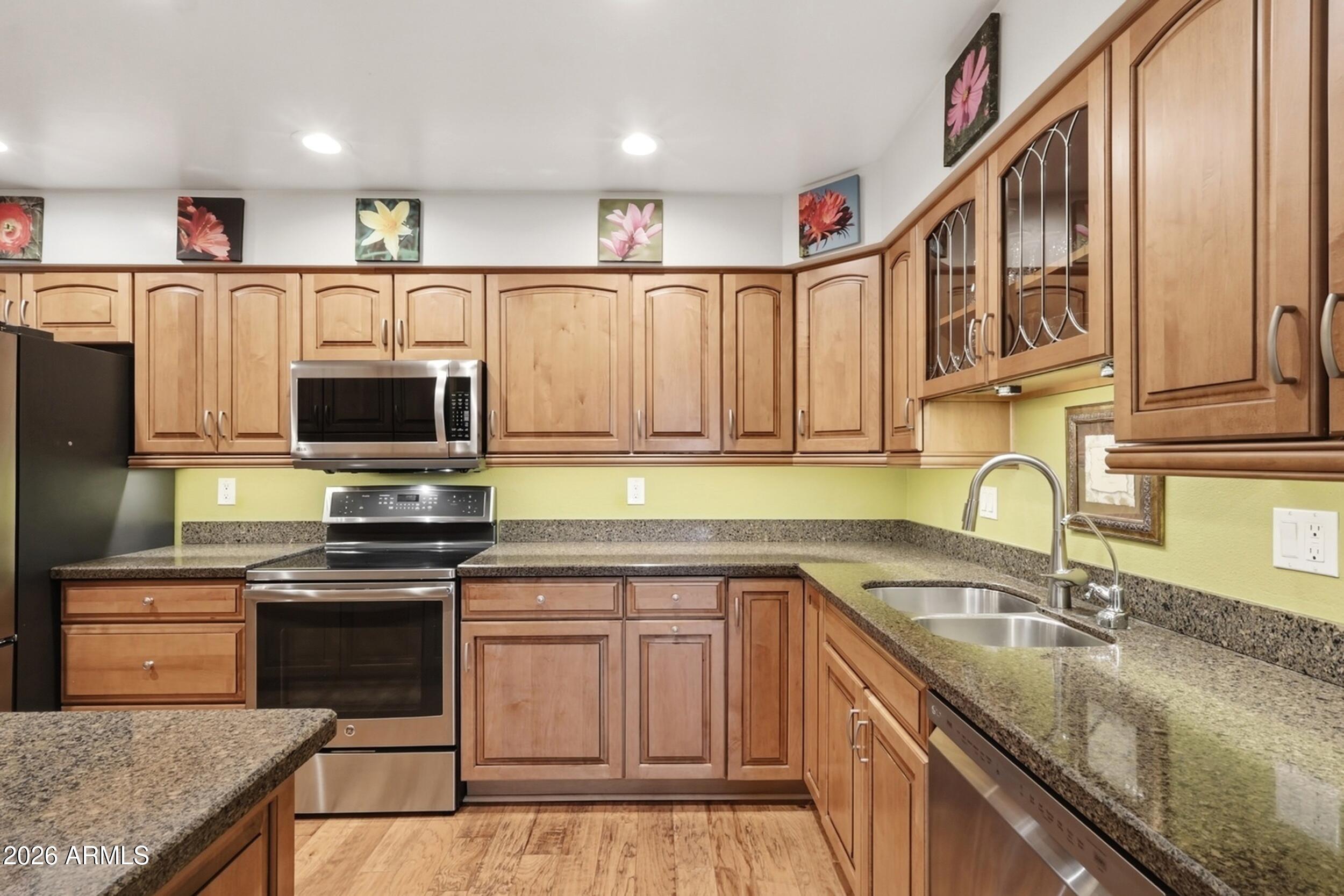 Welcome to this gorgeous, completely renovated east-facing townhouse offering spectacular mountain & pool views! Step inside to discover a floor plan designed for effortless flow. The living spaces shine with custom paint, elegant crown molding, new fixtures, and stunning wood flooring throughout the living room, kitchen, and hallway. You will love the plush carpet in the bedrooms and the easy-maintenance tile in the baths and laundry room. The completely redesigned kitchen is a chef's dream, expertly maximizing storage with beautiful maple cabinets and rollout drawers, granite countertops, under-cabinet lighting, and all newer appliances that convey-including an induction range! Beyond your front door, enjoy unmatched resort-style community amenities featuring three pools, two spas, pickleball, well-maintained sport courts, a fully equipped fitness center, and numerous hobby rooms--including a full woodworking shop. This designer showcase is a must-see and completely move-in ready!