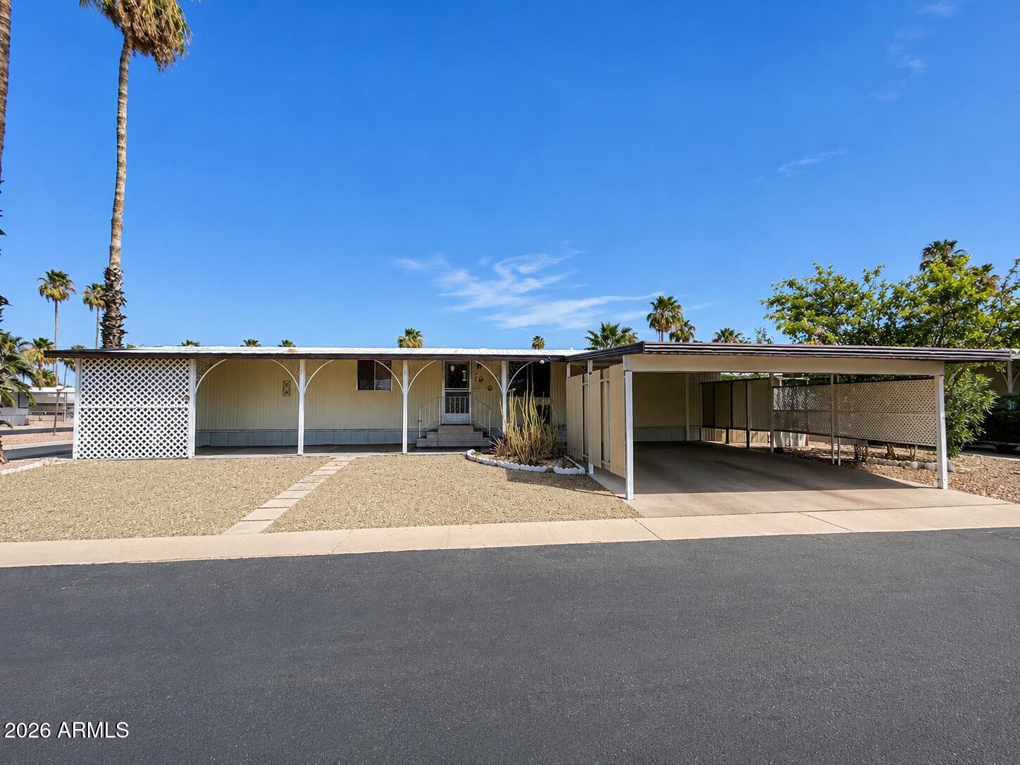 BIG VALUE. BIG LOT. BIG OPPORTUNITY IN CIELO GRANDE! Priced at just $19,500, this clean and comfortably sized 2-bedroom, 2-bath home delivers an exceptional opportunity to enjoy 55+ resort-style living without the premium price tag.

Set on a desirable large corner lot, this approximately 896-square-foot home offers a sought-after split-bedroom floorplan, creating welcome privacy between the primary suite and guest bedroom. The open living area feels generous for a home of this size, while the eat-in kitchen provides ample cabinetry, laminate counters, gas cooking, and included appliances.

The primary bedroom features its own attached full bath, while the secondary bedroom and bathroom are ideally positioned for guests, hobbies, or a home office. Laminate flooring throughout most of t home adds easy-care appeal, with tile in the secondary bath. Washer and dryer convey for added convenience.

Outside, the rare side-by-side 2-car covered carport is a standout feature, along with covered outdoor space, storage sheds, low-maintenance desert landscaping, and a citrus tree. This is an excellent chance to personalize a well-kept home with solid bones, a functional layout, and room to make it your own.

Located in gated Cielo Grande, residents enjoy access to a heated community pool and spa, clubhouse, fitness area, recreation opportunities, and an active 55+ lifestyle. At this price point, opportunities like this are hard to find--come see the value for yourself.