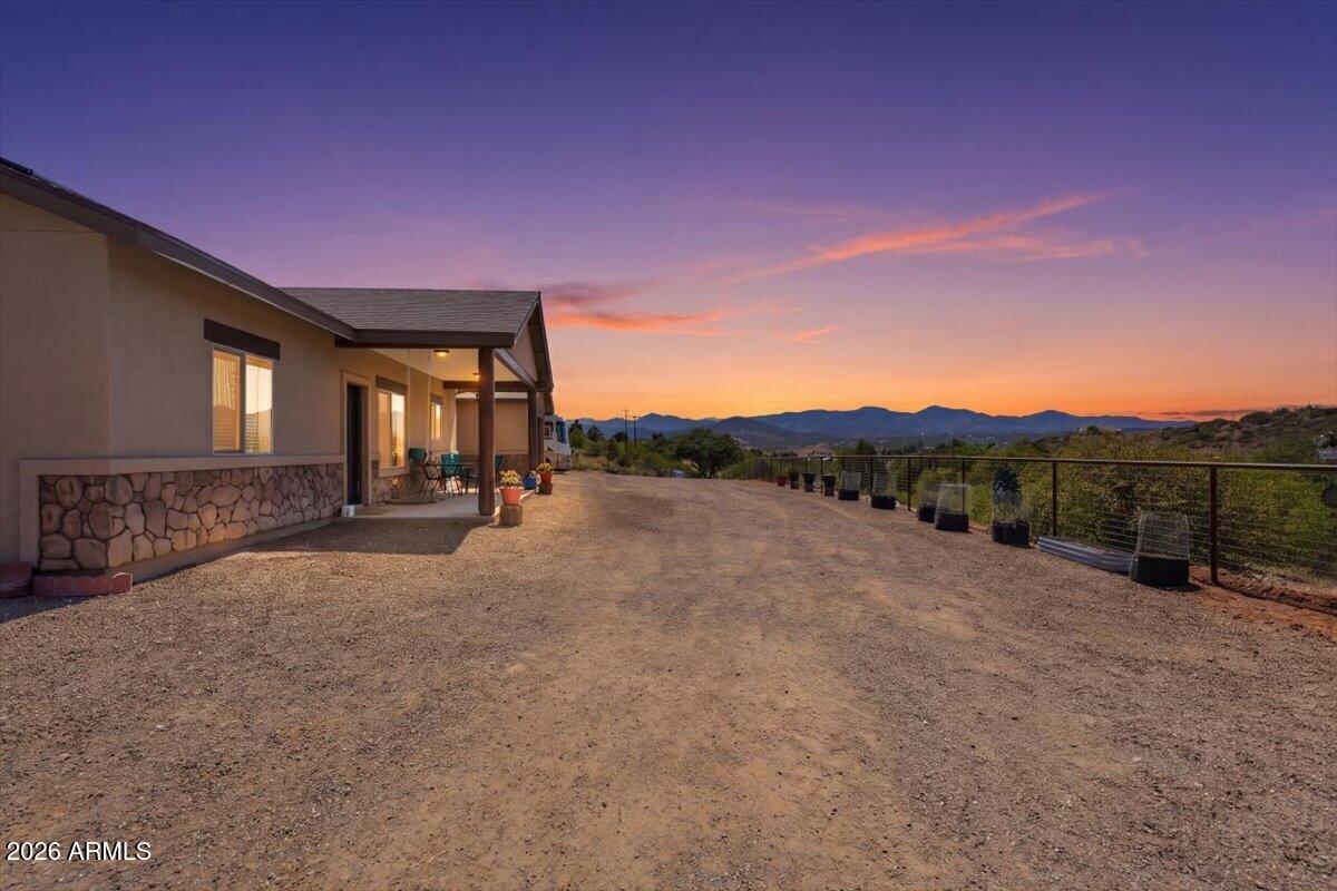 Looking for privacy, acreage, and breathtaking views with NO HOA? This beautiful semi-custom home on 2.42 acres offers the perfect blend of comfort, space, and Arizona charm. Featuring 3 bedrooms+ office/den, 2.5 bathrooms, and a spacious open floor plan designed for everyday living and entertaining. The kitchen shines with tall hickory cabinets, granite countertops, stainless steel appliances, a center island, and tile flooring. Purification water system and leased solar. The inviting great room boasts vaulted ceilings, recessed lighting, and a warm mix of carpet and tile floors. The spacious primary suite includes dual vanities, a soaking tub, separate shower, and two walk-in closets. Step outside to enjoy the fully fenced property, RV parking, private backyard, peaceful seclusion w/view
